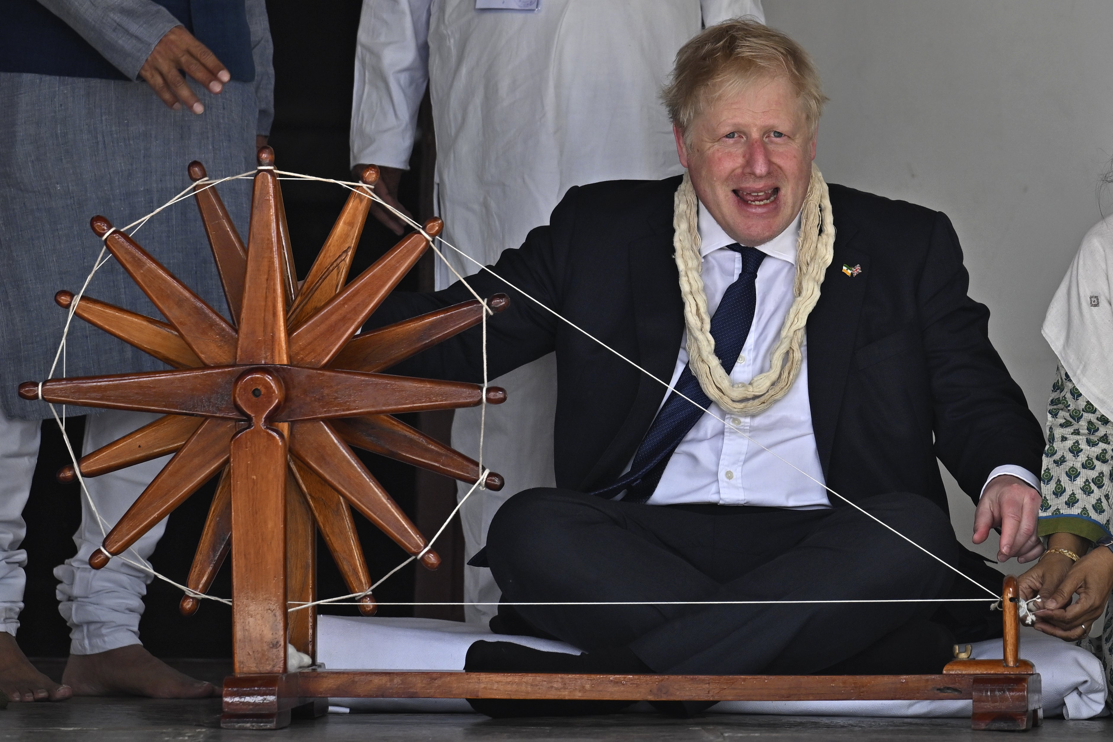 Prime Minister Boris Johnson spins khadi on a charkha during his visit to Mahatma Gandhi’s Sabarmati Ashram in Ahmedabad, as part of his two-day trip to India (Stefan Rousseau/PA)