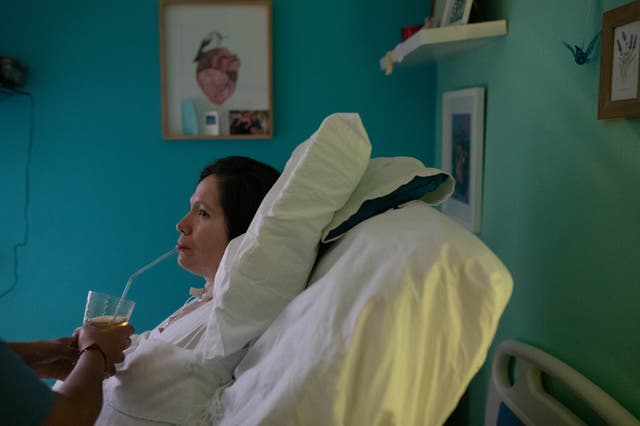 <p>One of her nurses helps Estrada with her lunch</p>