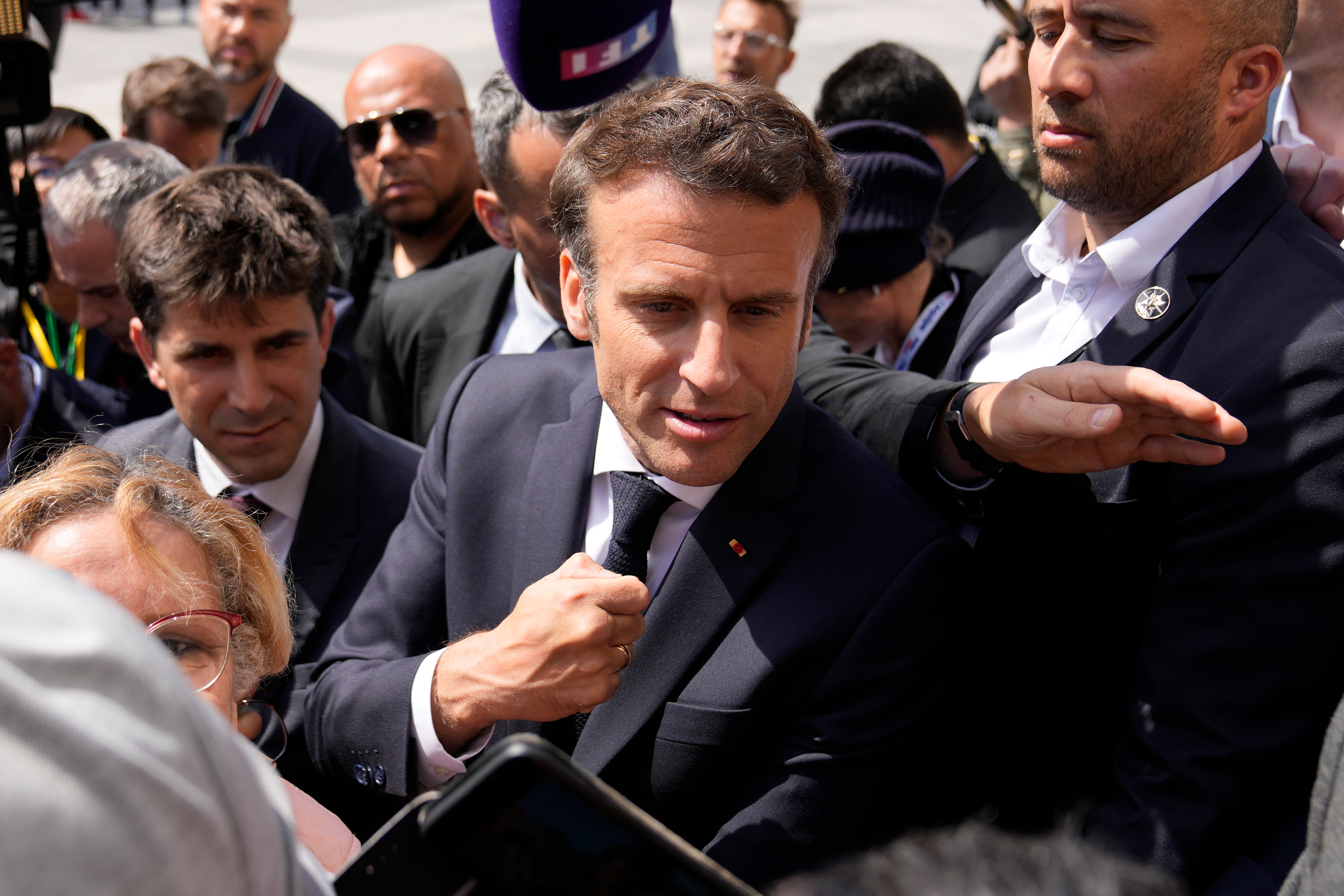 French president Emmanuel Macron meets residents during a campaign stop in Saint-Denis, outside Paris, on Thursday