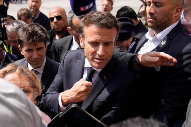 <p>French president Emmanuel Macron meets residents during a campaign stop in Saint-Denis, outside Paris, on Thursday</p>