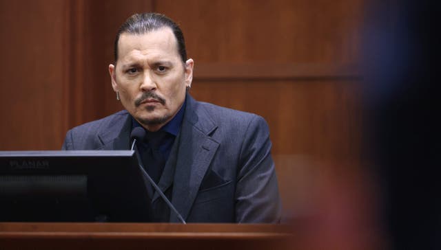 <p>Actor Johnny Depp testifies during his defamation trial against his ex-wife Amber Heard, at the Fairfax County Circuit Courthouse in Fairfax, Virginia, April 21, 2022</p>