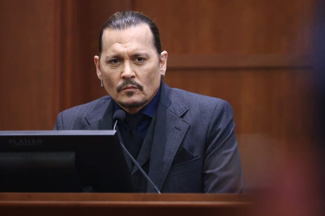 <p>Actor Johnny Depp testifies during his defamation trial against his ex-wife Amber Heard, at the Fairfax County Circuit Courthouse in Fairfax, Virginia, April 21, 2022</p>