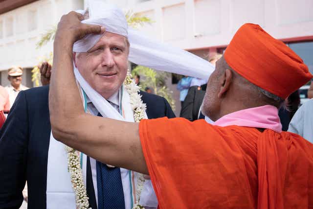 <p>The PM having a turban placed on his head at a university in Gujarat, India, on Thursday</p>