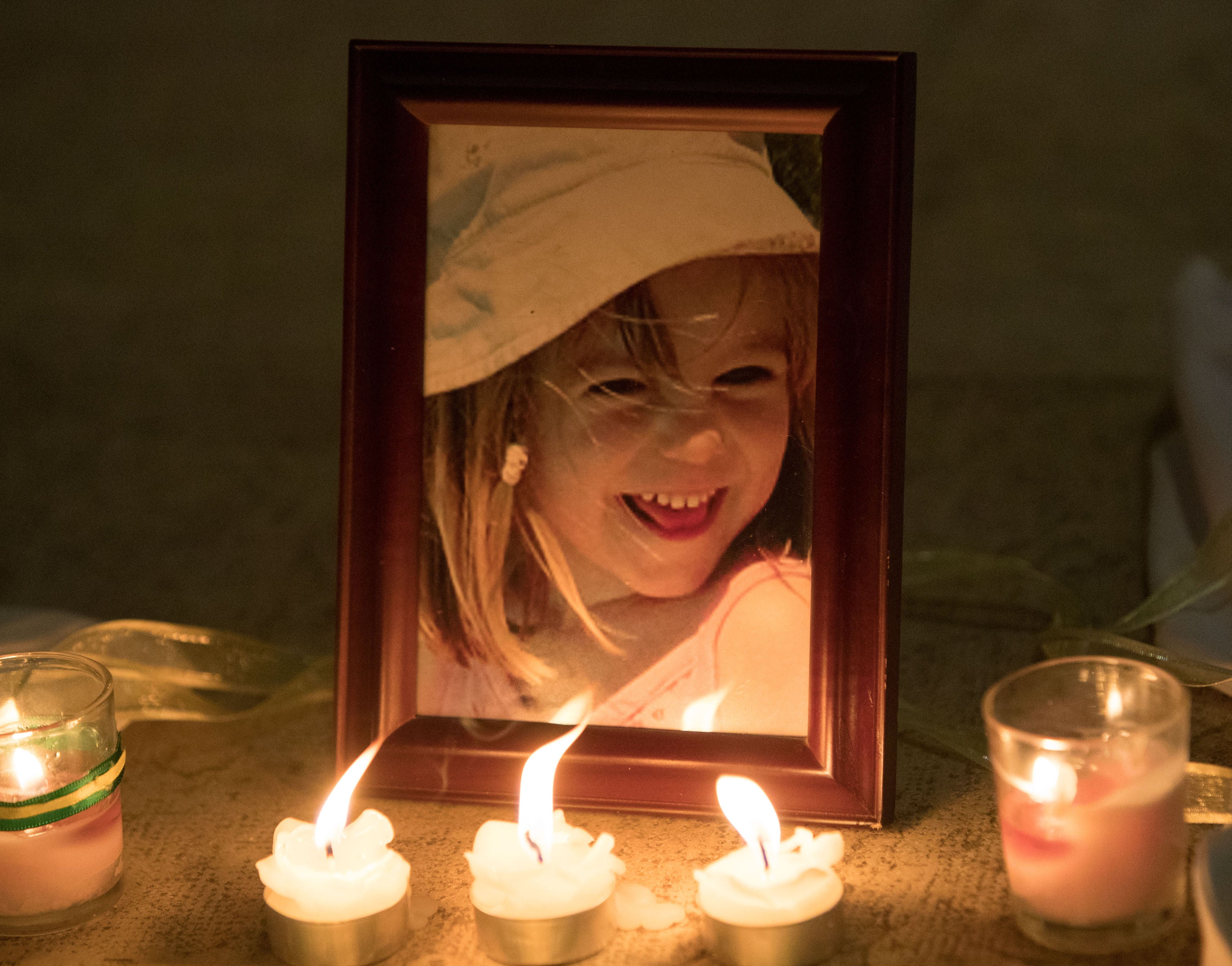 Candles next to a photo of Madeleine McCann inside the Church of Nossa Senhora da Luz in Praia da Luz