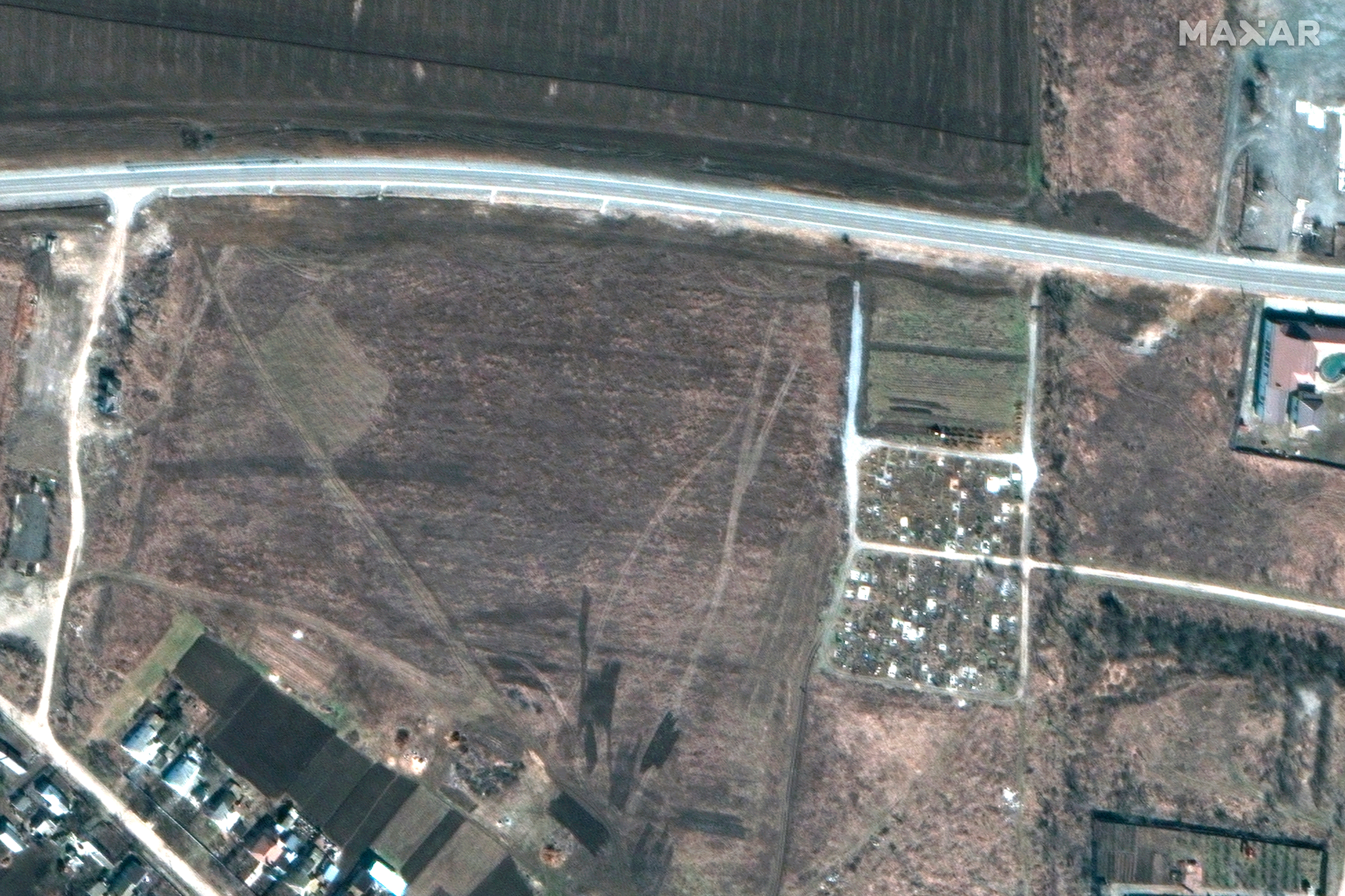 Satellite images provided by Maxar Technologies show an overview of a cemetery in Manhush, west of Mariupol