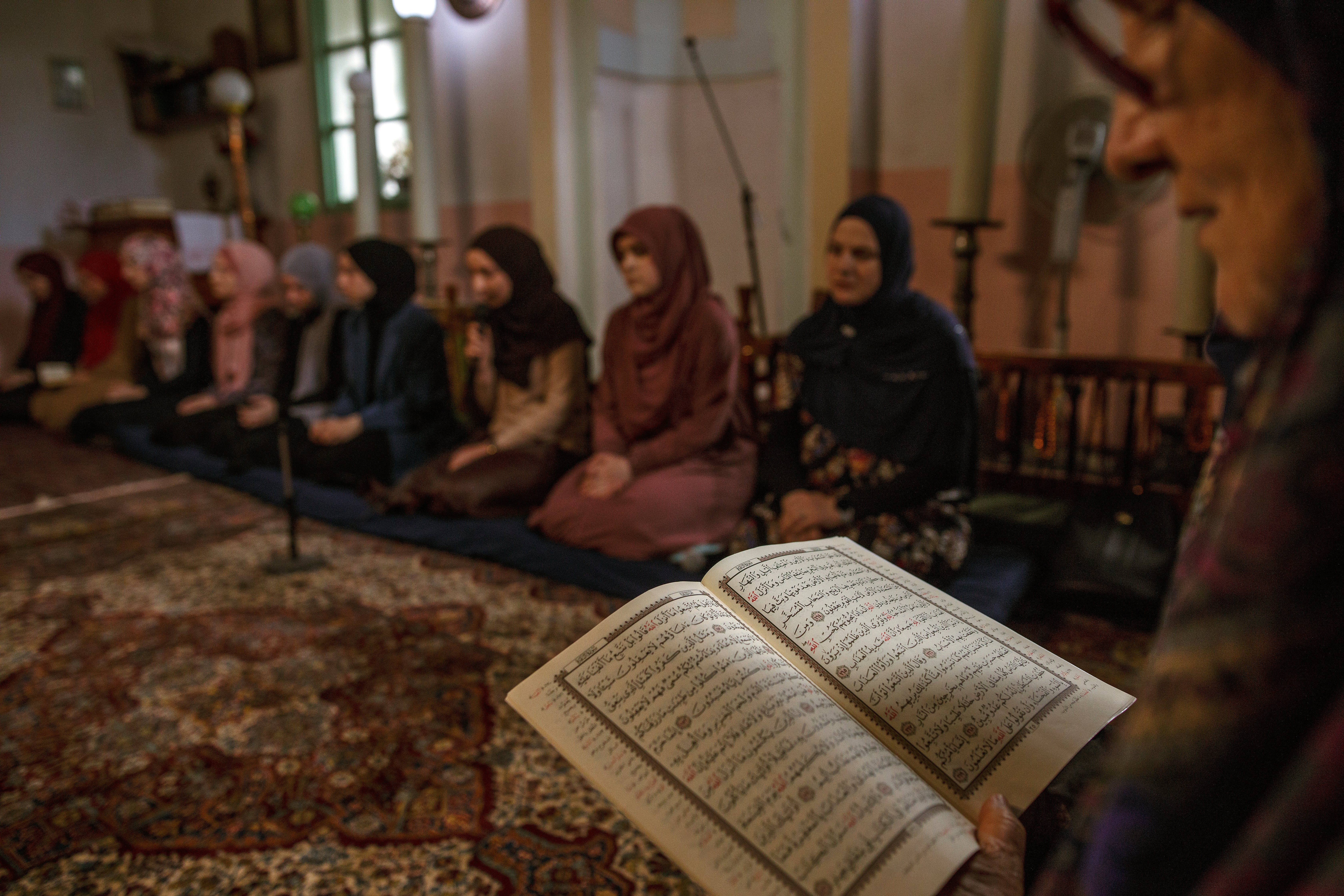 Bosnian hafizas, women who have memorised the Quran, recite from the holy book during the mukabela ceremony at Hadzijska mosque