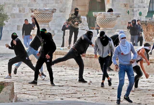 <p>Palestinian demonstrators clash with Israeli police at Jerusalem's Al-Aqsa mosque compound after the morning prayer</p>