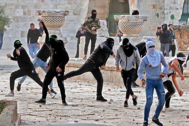 <p>Palestinian demonstrators clash with Israeli police at Jerusalem's Al-Aqsa mosque compound after the morning prayer</p>