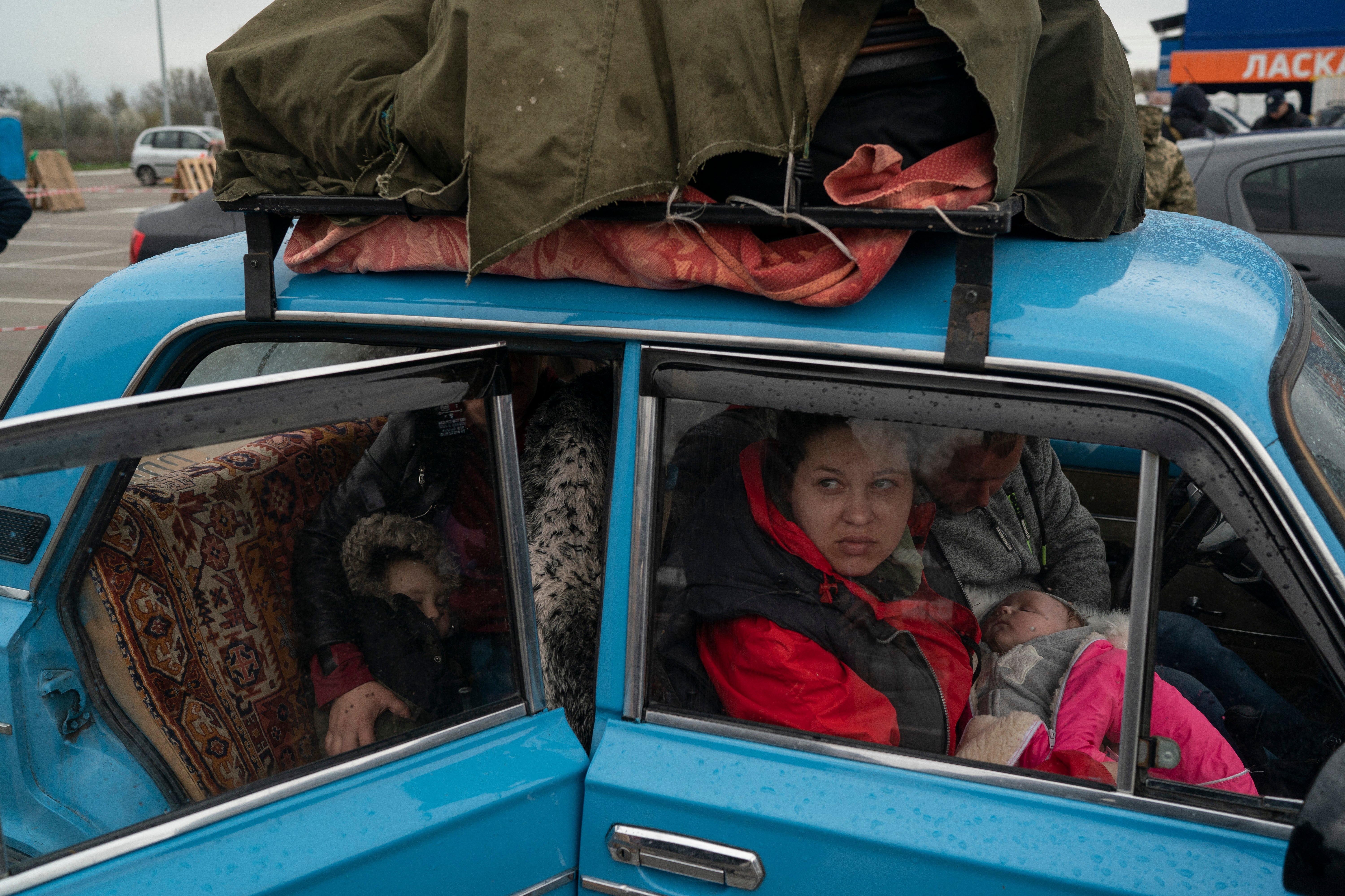 Internally displaced people from Mariupol and nearby towns arrive at a refugee center fleeing from the Russian attacks