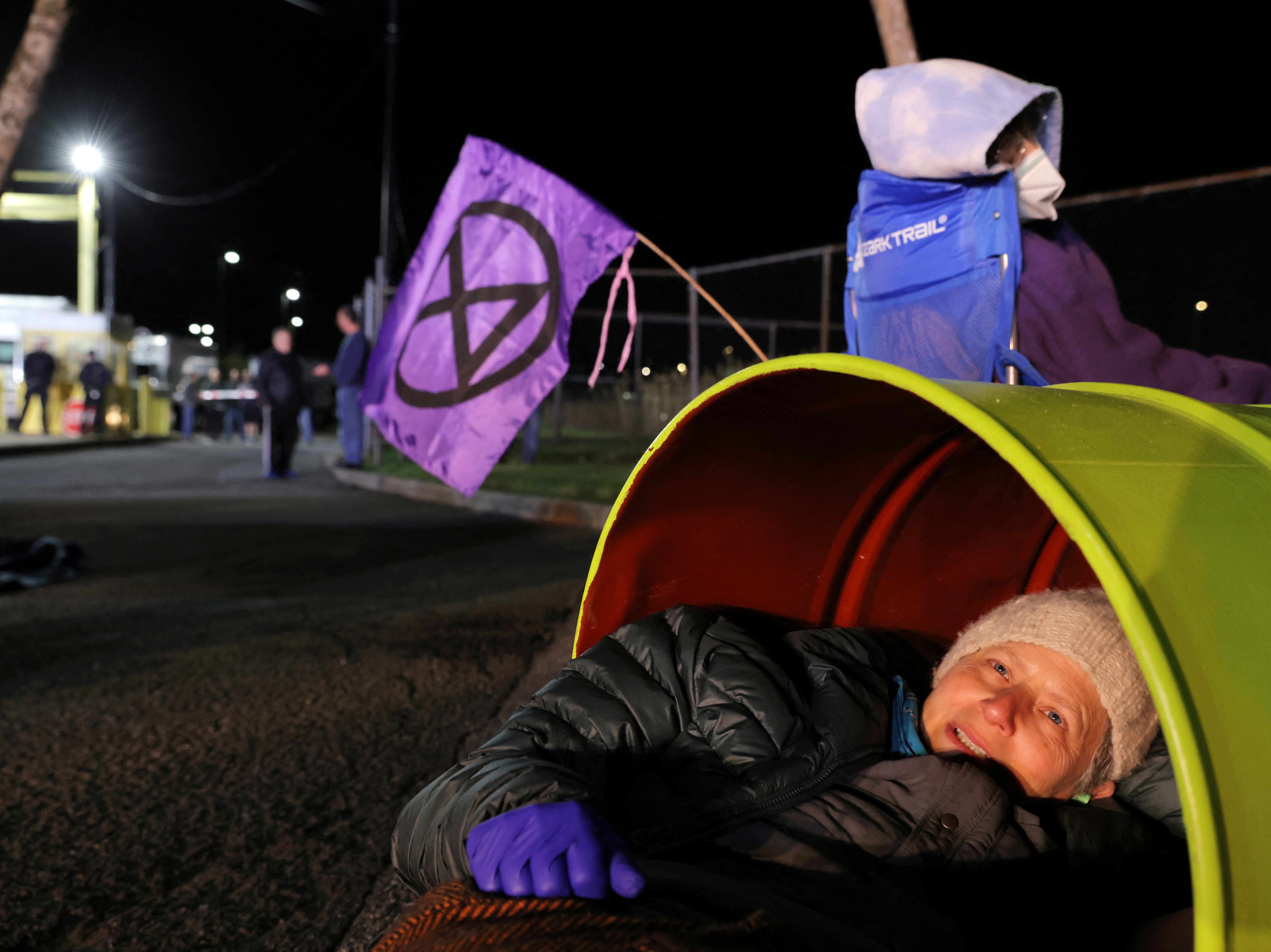 Activists from Extinction Rebellion take part in an Earth Day demonstration blockading the gate of The New York Times Distribution print facility