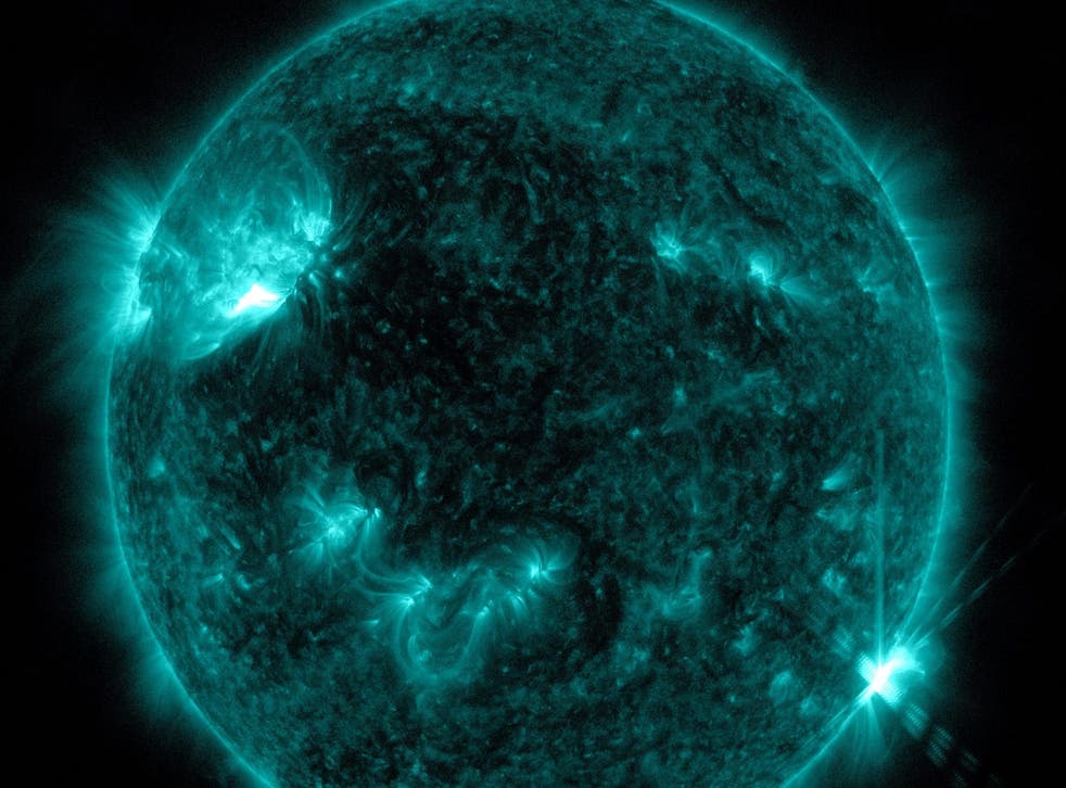 <p>NASA’s Solar Dynamics Observatory captured this image of a solar flare – as seen in the bright flash in the lower right portion of the image</p>