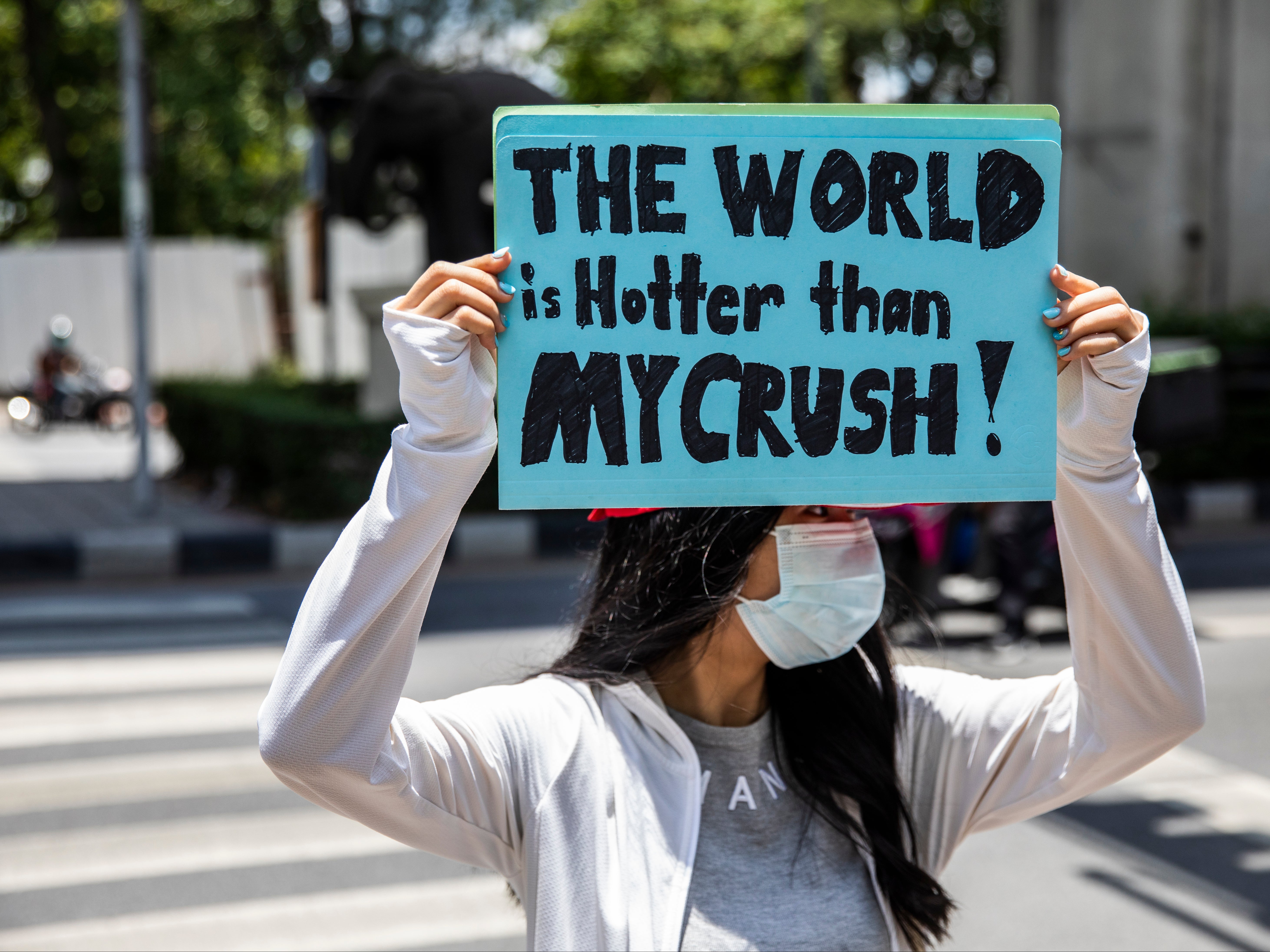 Environmental activists hold a sign during an Earth Day rally in Bangkok