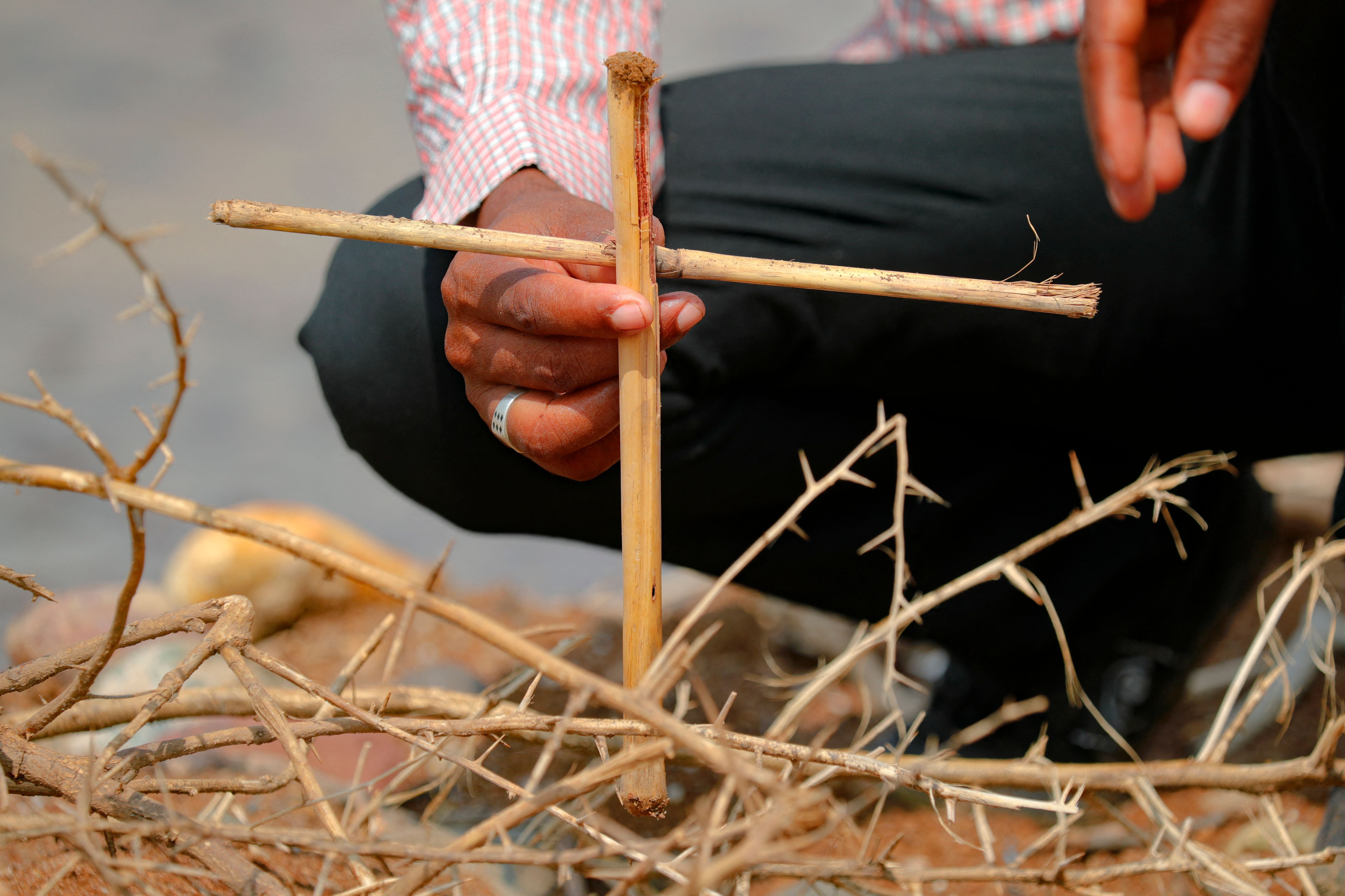 File photo: A Tigrayan refugee places a makeshift cross on the banks of the Setit river bordering Ethiopia, at the village of Wad al-Hiliou