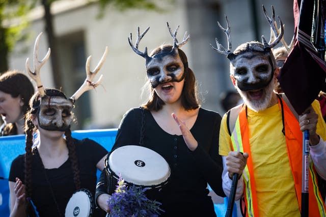 <p>Extinction Rebellion activists march to the Wilson Building, the seat of DC’s local governance, for an Earth Day protest to ‘stop all new fossil fuel infrastructure in the nation’s capital'</p>