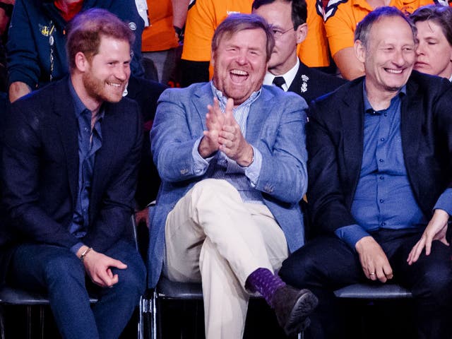<p>Prince Harry watches the wheelchair basketball final with King Willem-Alexander (centre) and Dutch General Mart de Kruif on Friday 22 April</p>