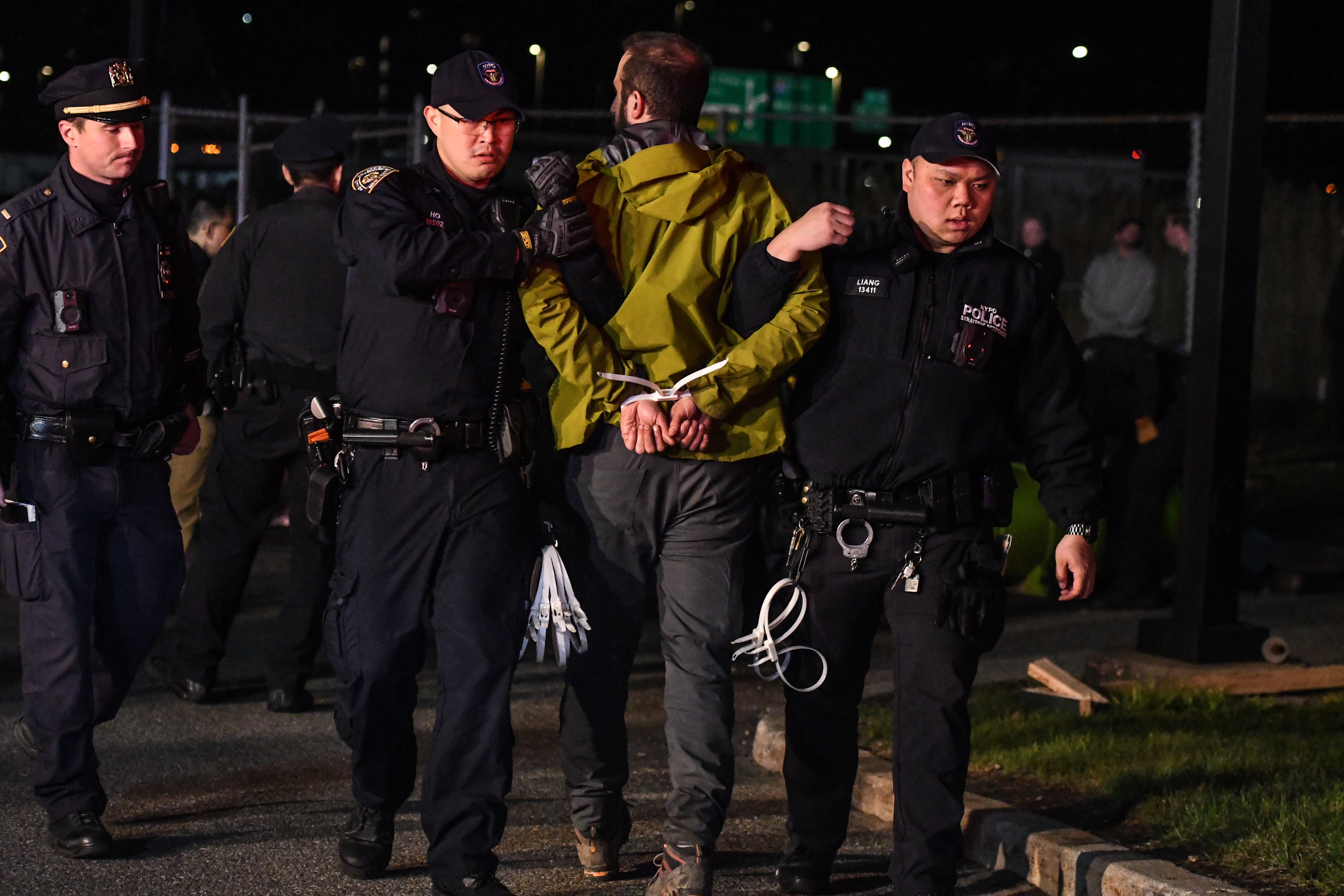 Police arrest an activist with Extinction Rebellion after the group protested at the New York Times printing press