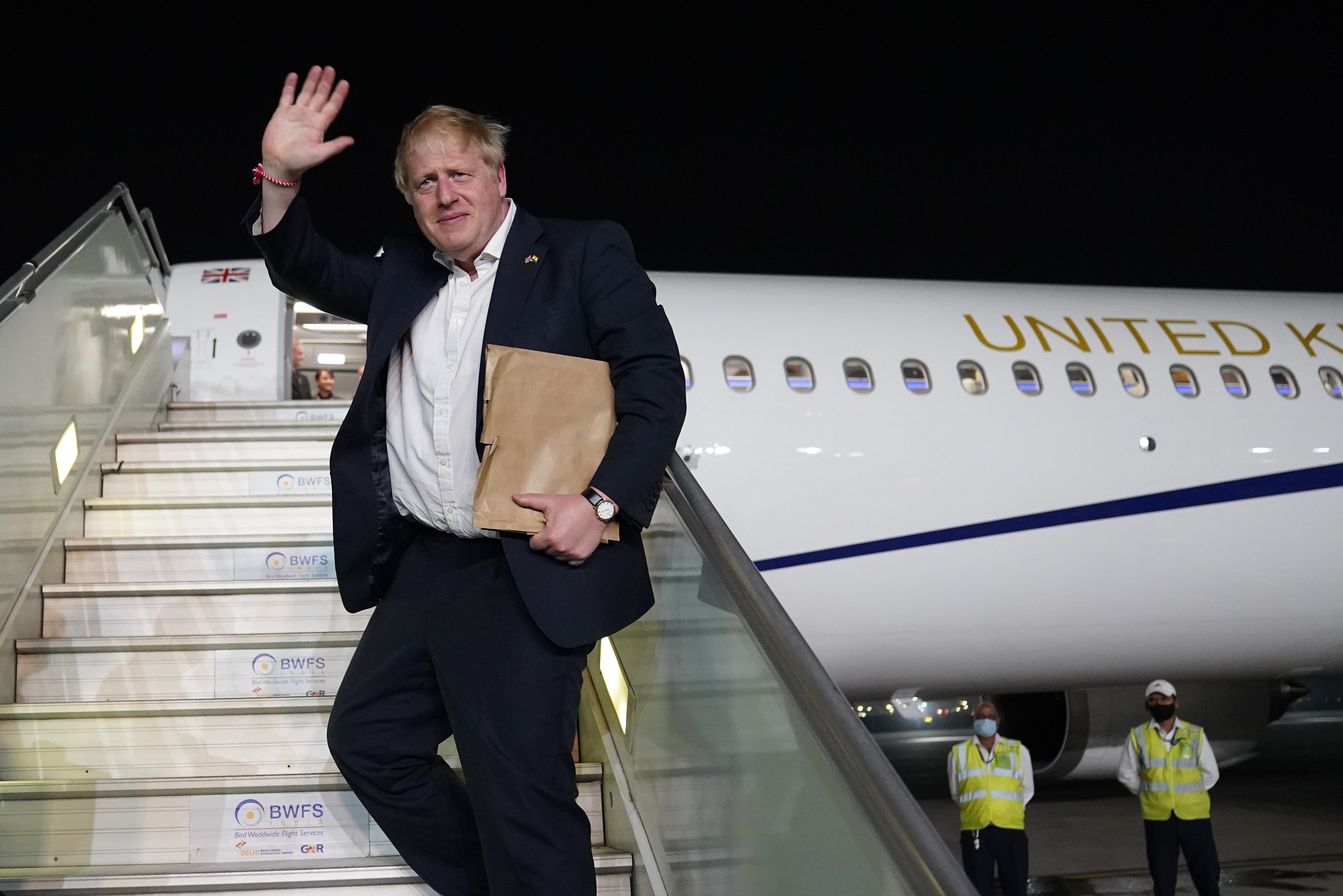 Prime Minister Boris Johnson waves as his boards his plane for the UK at Delhi airport at the end of his two-day trip to India (Stefan Rousseau/PA)