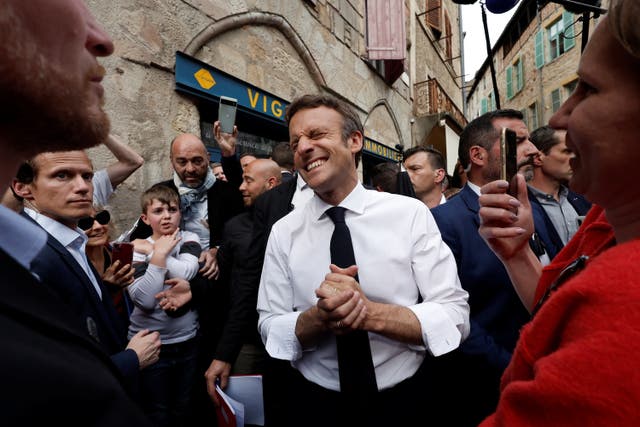 <p>French President Emmanuel Macron, candidate for his re-election in the 2022 French presidential election, reacts as he meets with supporters after a campaign rally in Figeac</p>