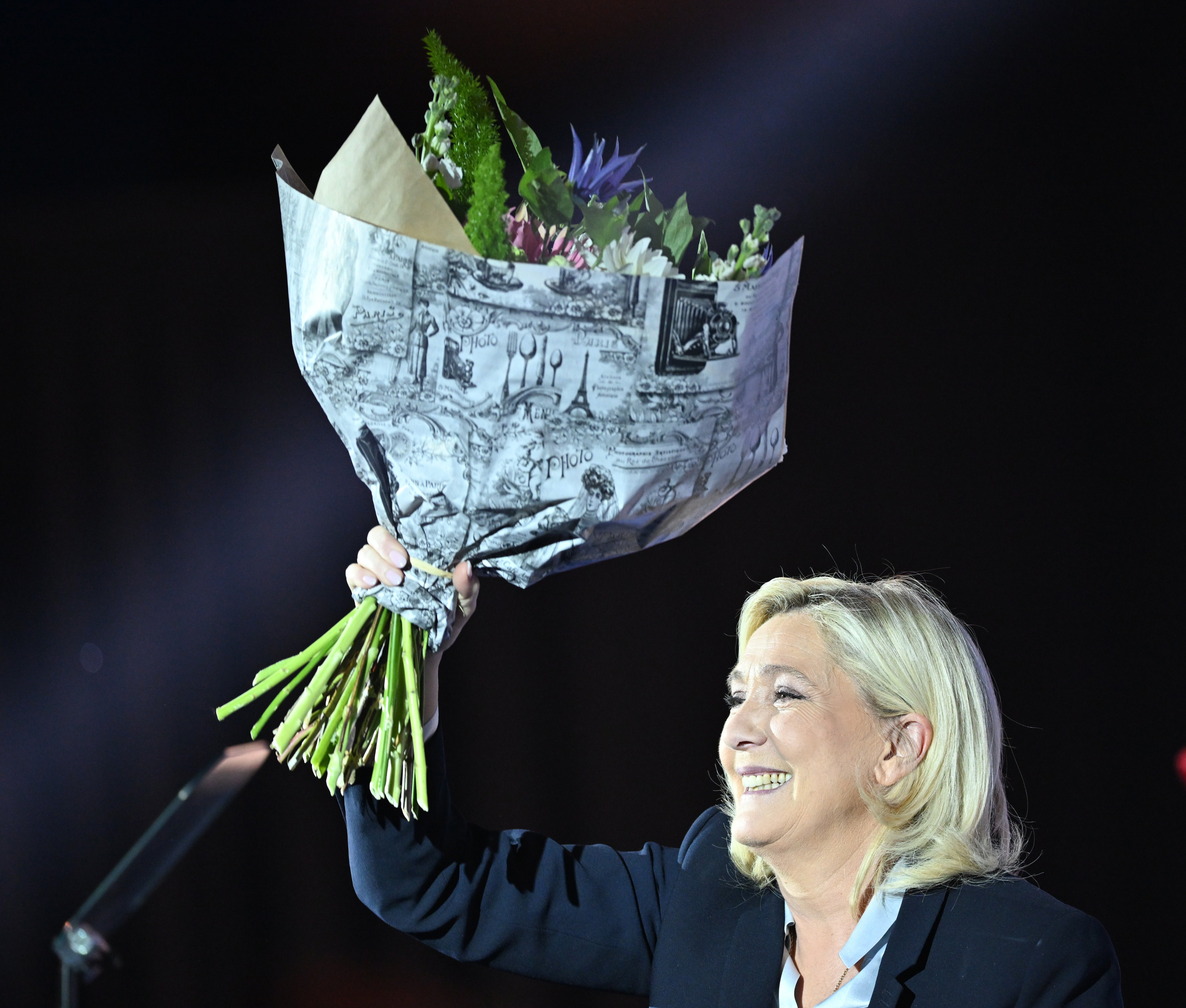 French far-right Rassemblement National (RN) party presidential candidate Marine Le Pen greets to her supporters during a campaign meeting at the Artois expo in Arras