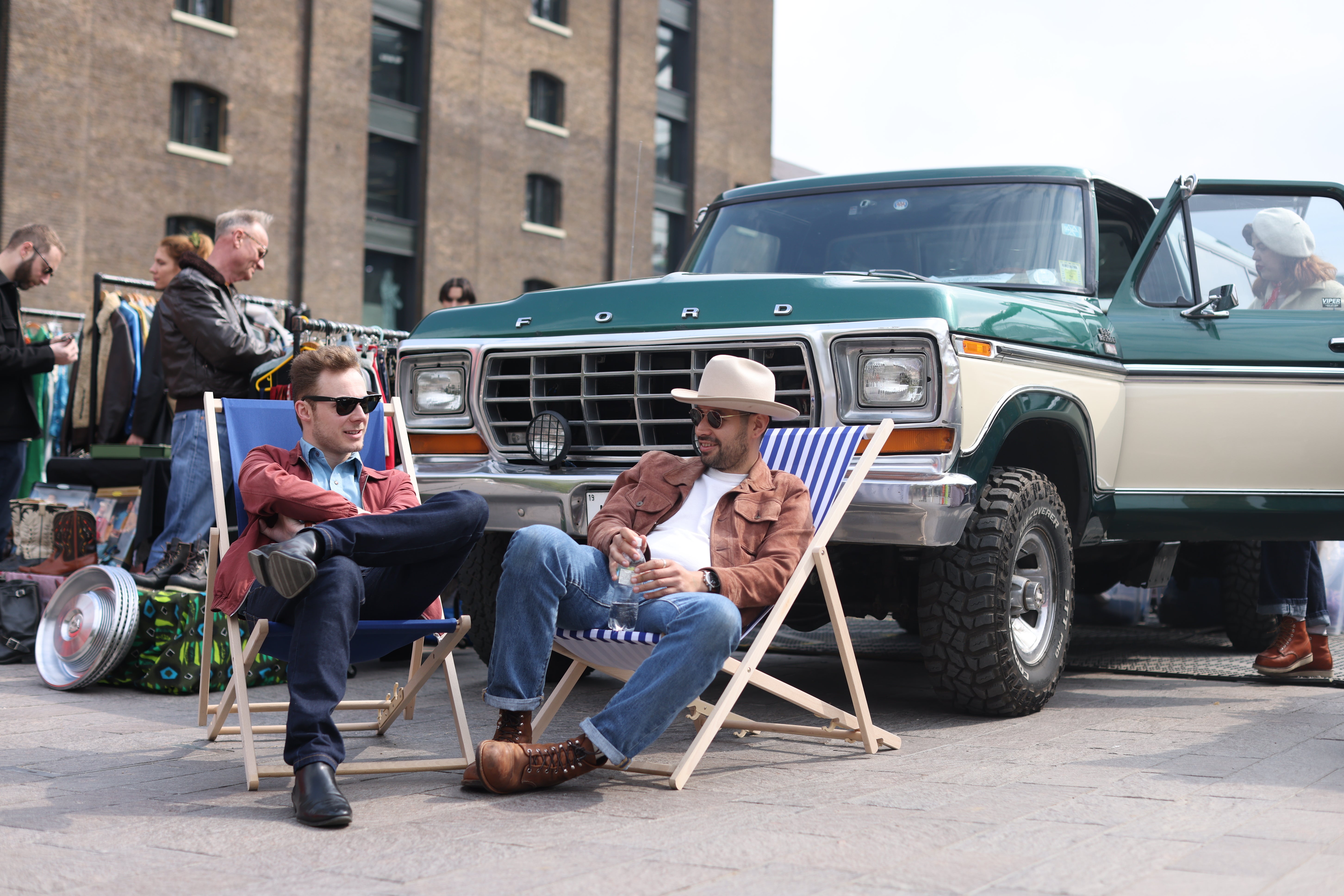 Two men sit in front of a classic Ford truck (James Manning/PA)