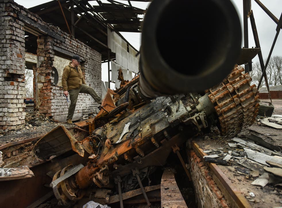 <p>A man explores a destroyed tank in Ivanivka village, Chernihiv</p>