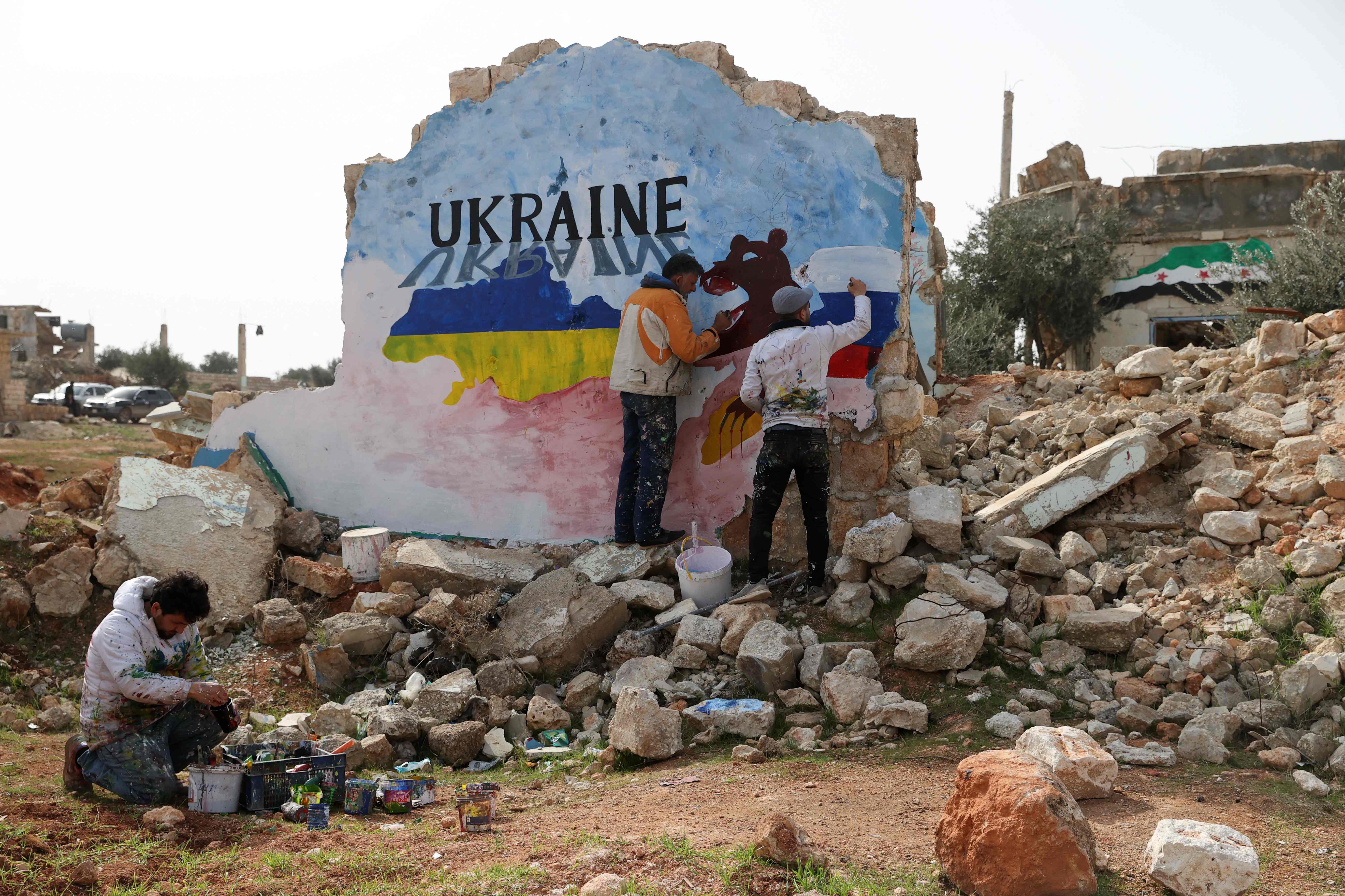 Artists in Idlib province paint a mural to protest against Russia's military operation in Ukraine