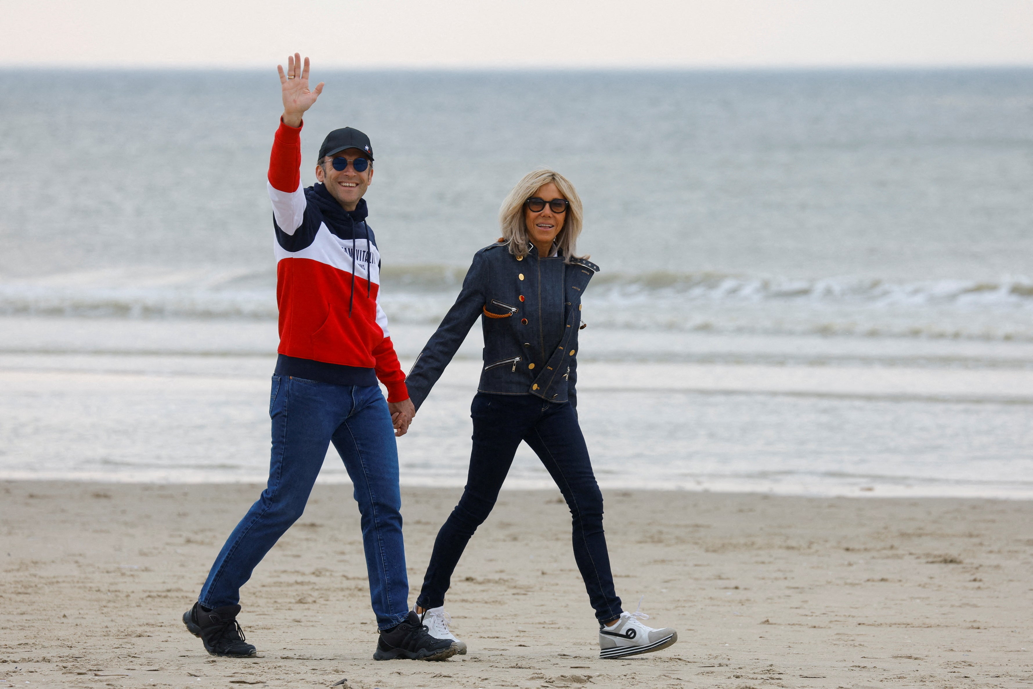 Emmanuel and Brigitte Macron walking on the beach during the presidential elections