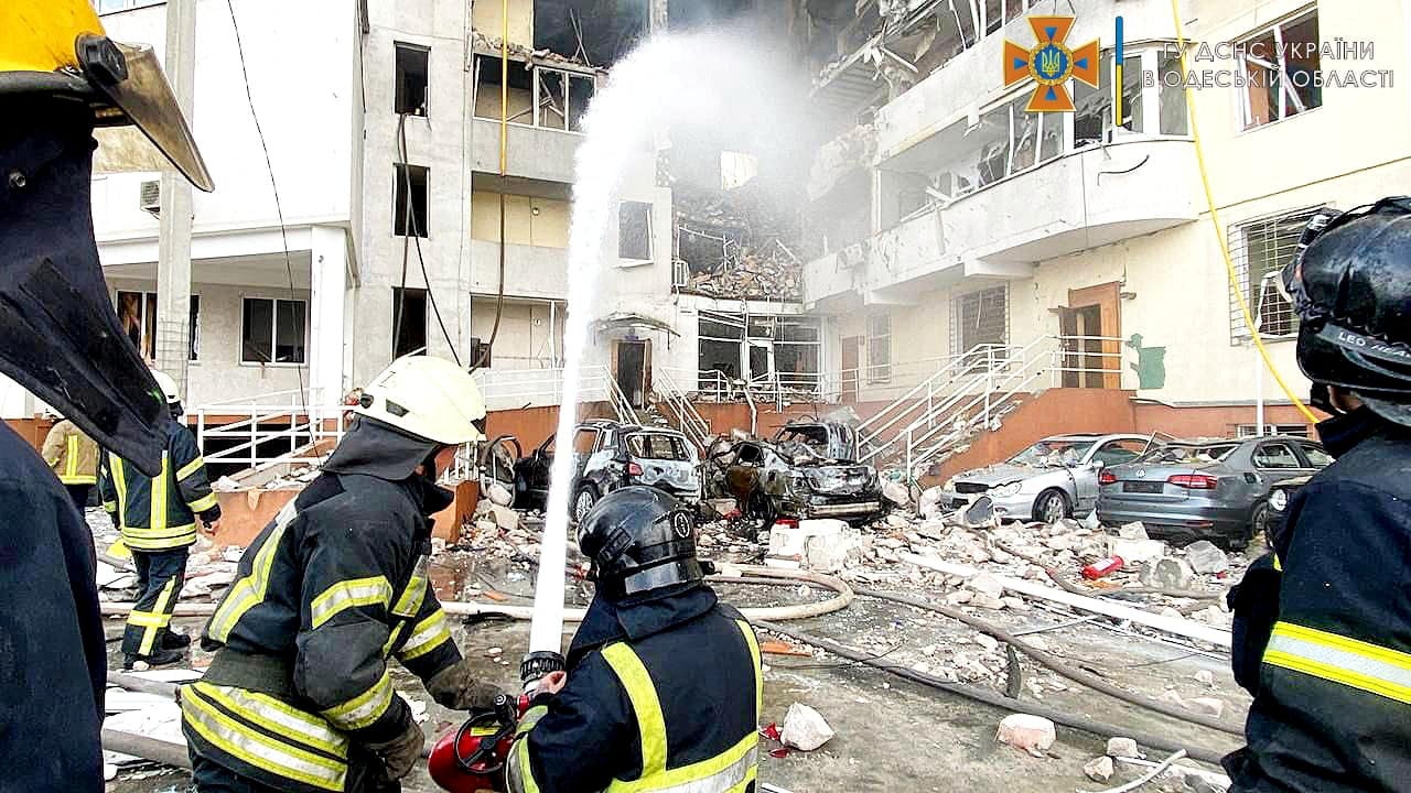 Emergency service workers extinguish fire after the missile strike in Odesa