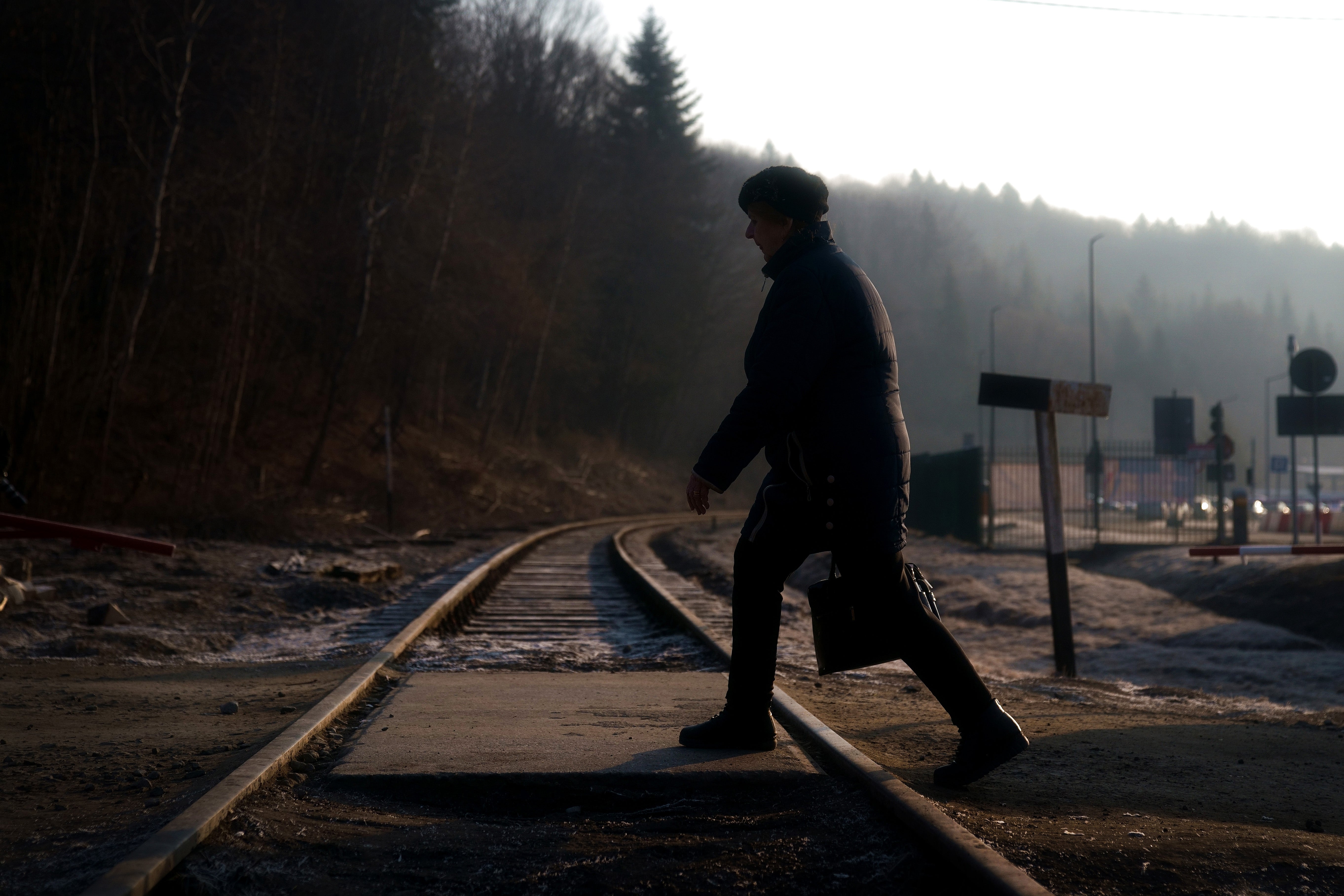 A woman from Ukraine walks over a railway line after crossing a border point into Poland at Kroscienko, in the south east of the country. Picture date: Saturday March 19, 2022 (Victoria Jones/PA)