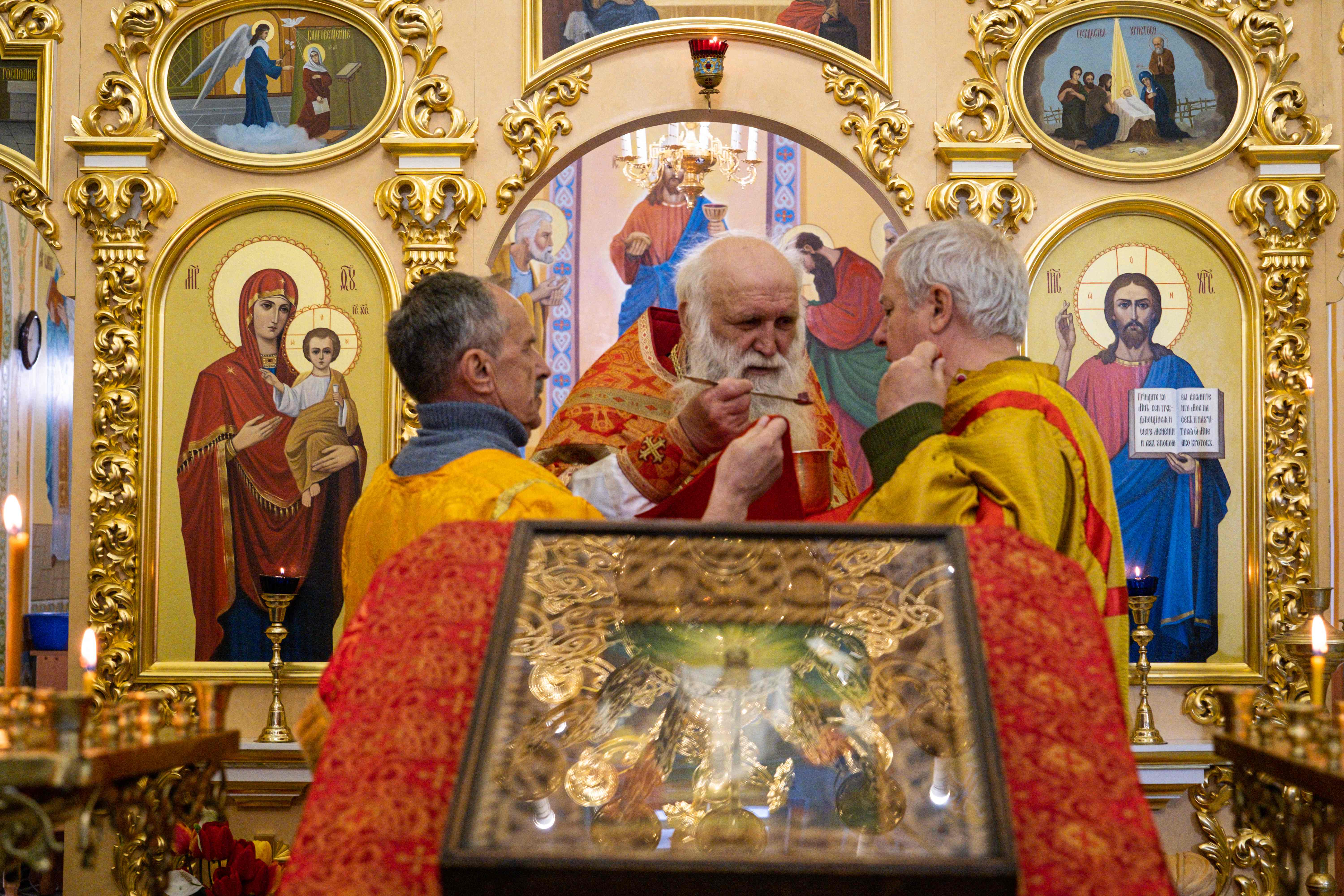 Priests conduct an Orthodox Easter service amid the sounds of shelling in Lyman, eastern Ukraine, on 24 April, 2022