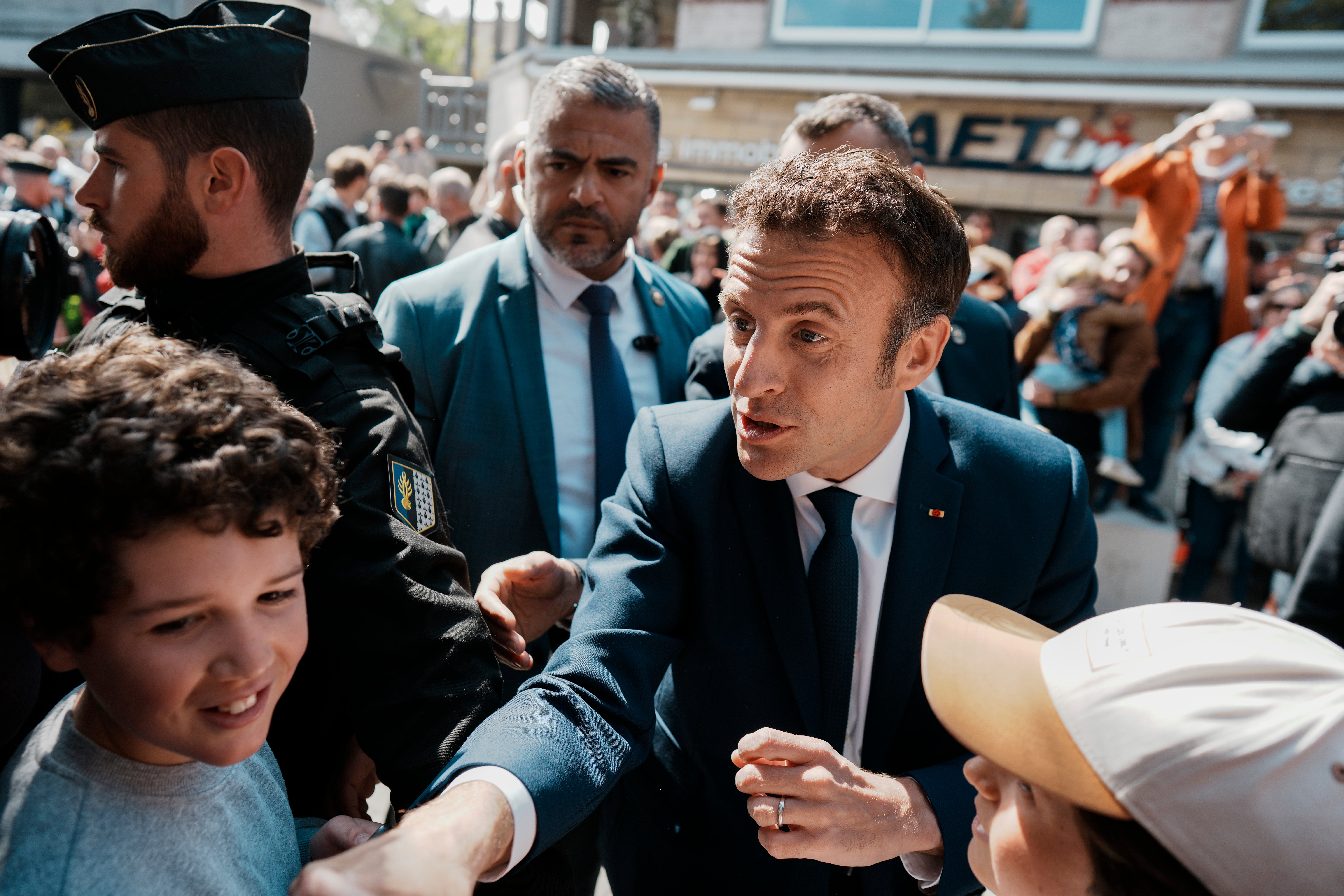 Emmanuel Macron greets well-wishes near a polling station in Le Touquet, northern France, on Sunday