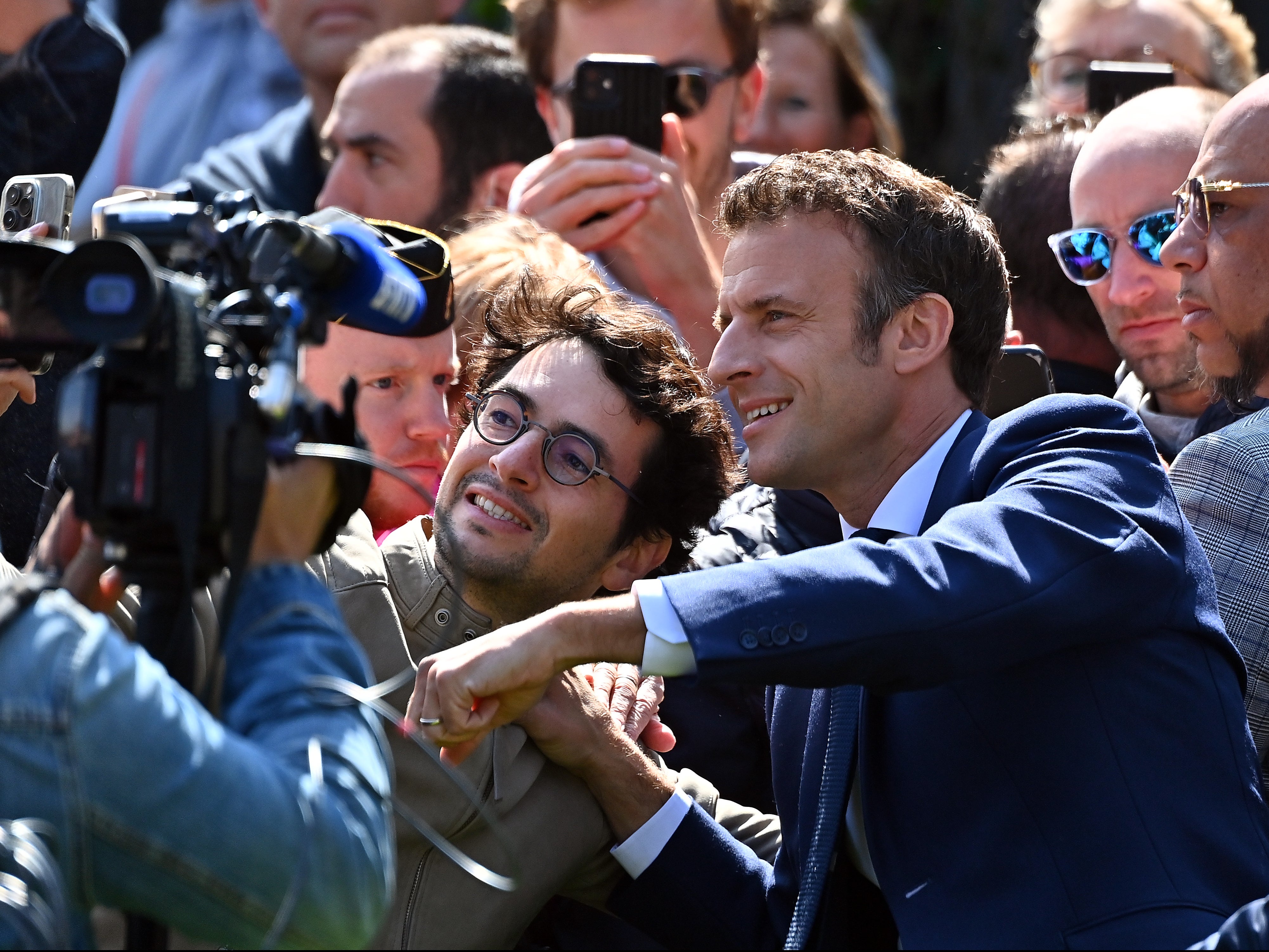 Emmanuel Macron meets voters as he leaves his house to vote