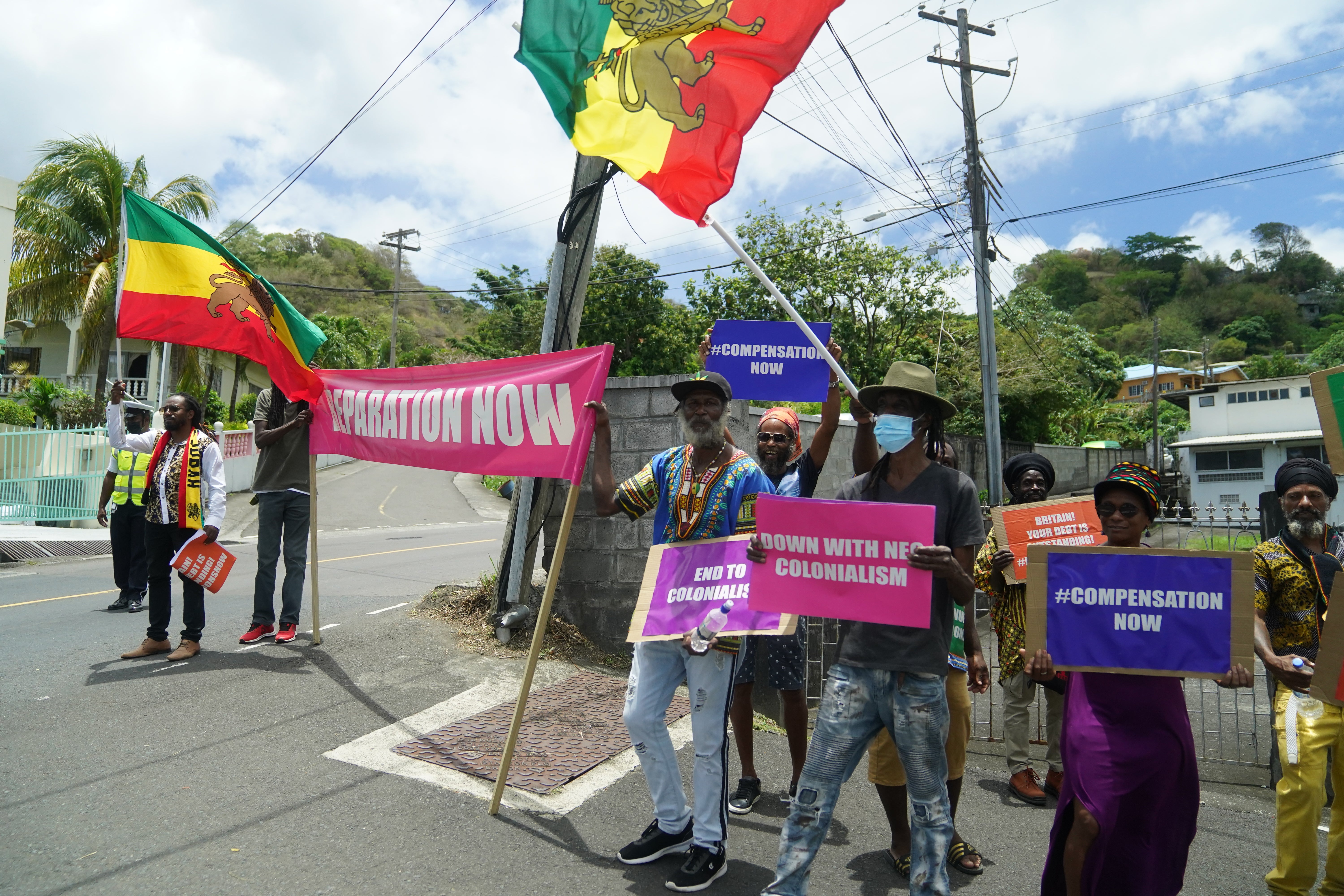 Protesters with with banners protesting against British colonialism in St Vincent and the Grenadines (Joe Giddens/PA)