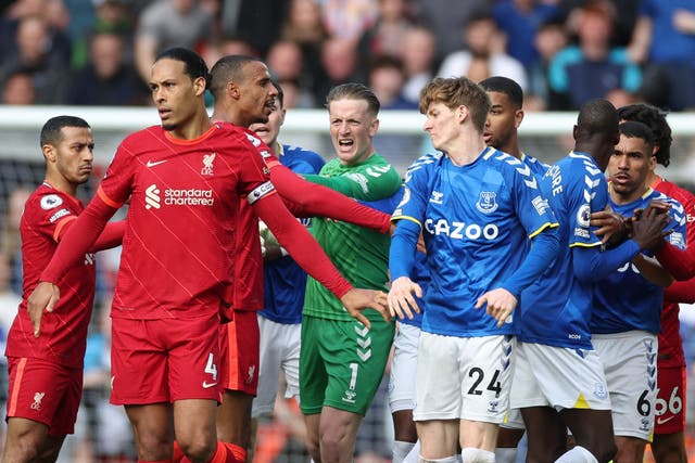 <p>Liverpool's Joel Matip clashes with Everton's Anthony Gordon</p>
