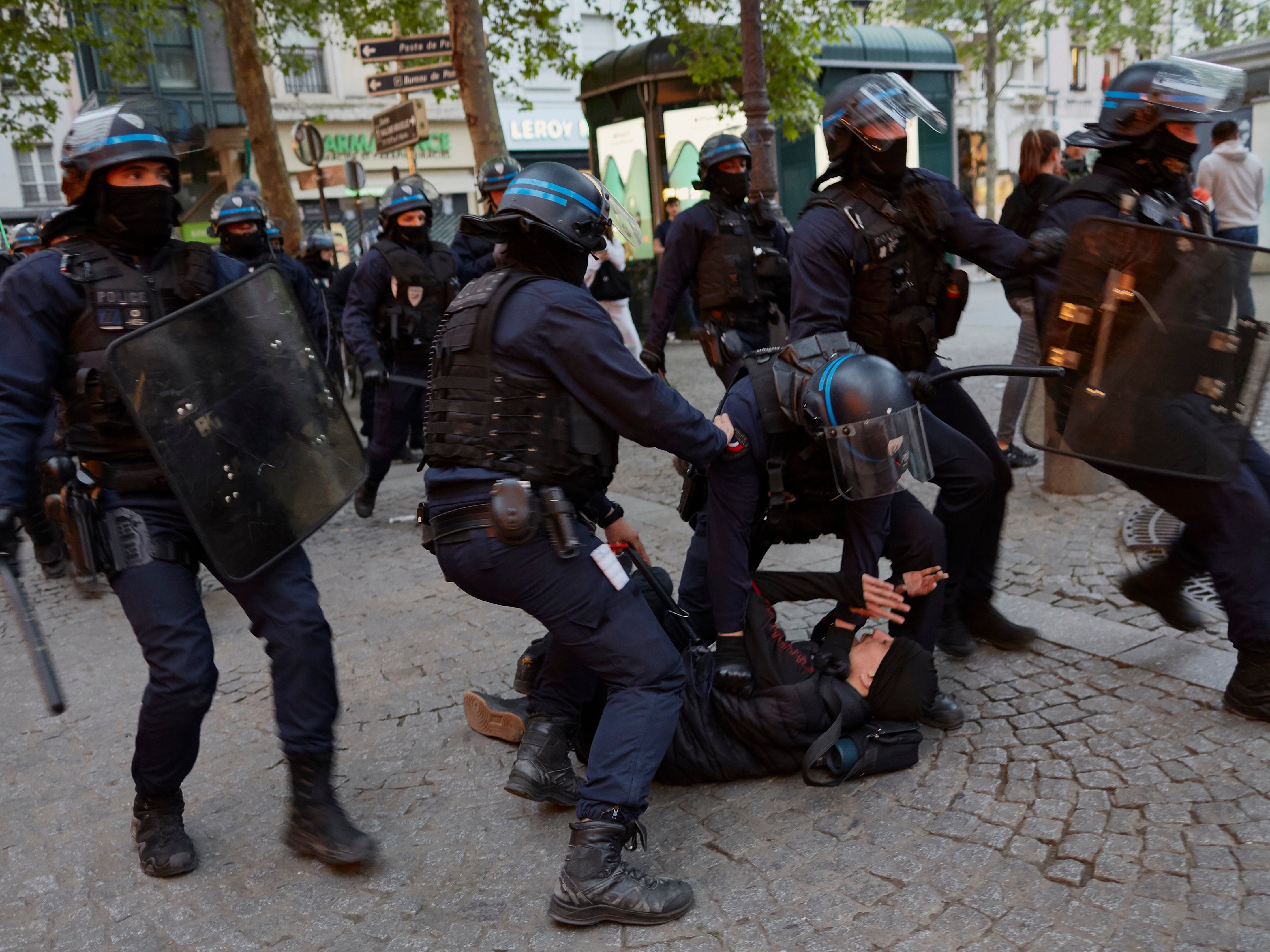 Police arrest a man during a protest against Macron’s victory on Place de la République