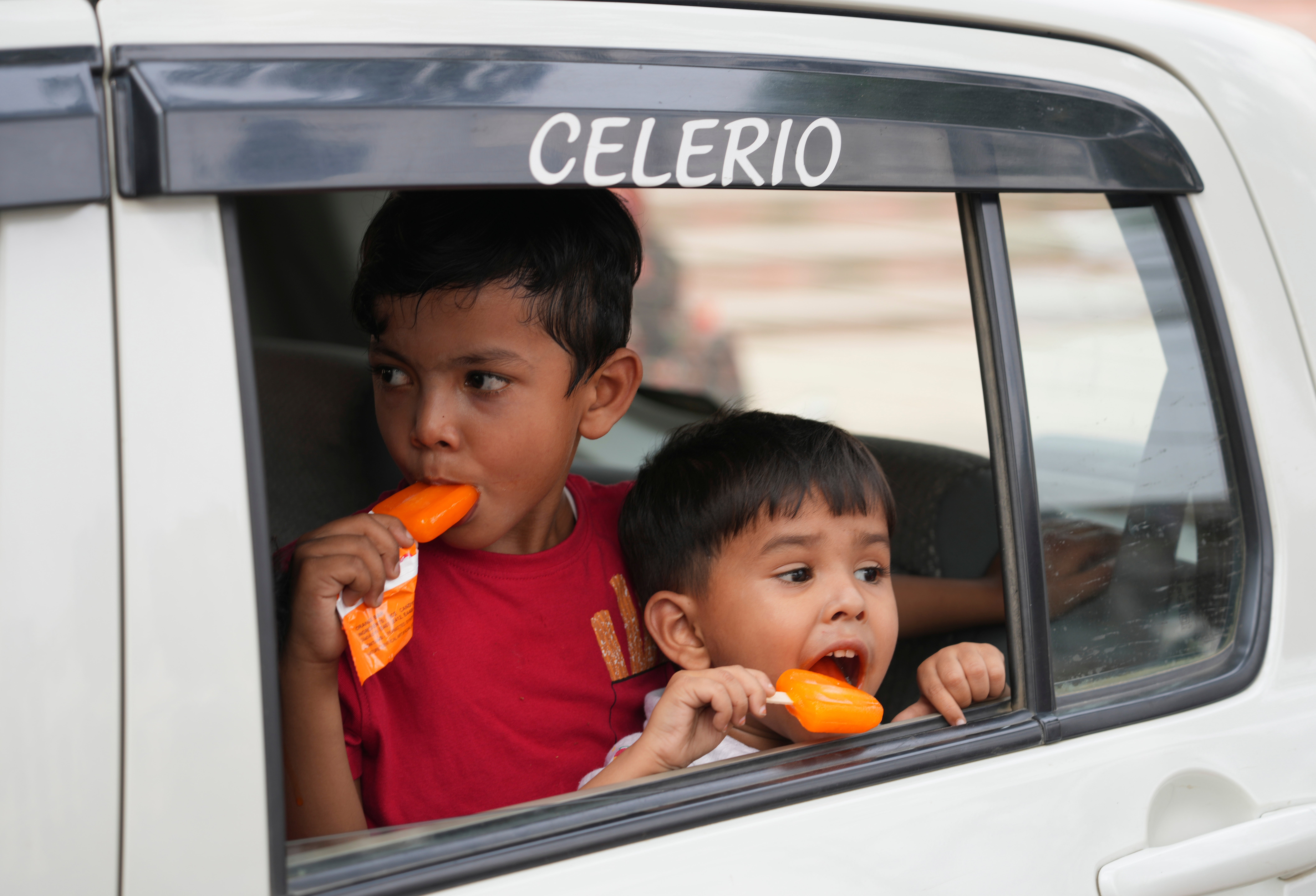 Children eat ice cream in Prayagraj, in the northern Indian state of Uttar Pradesh.