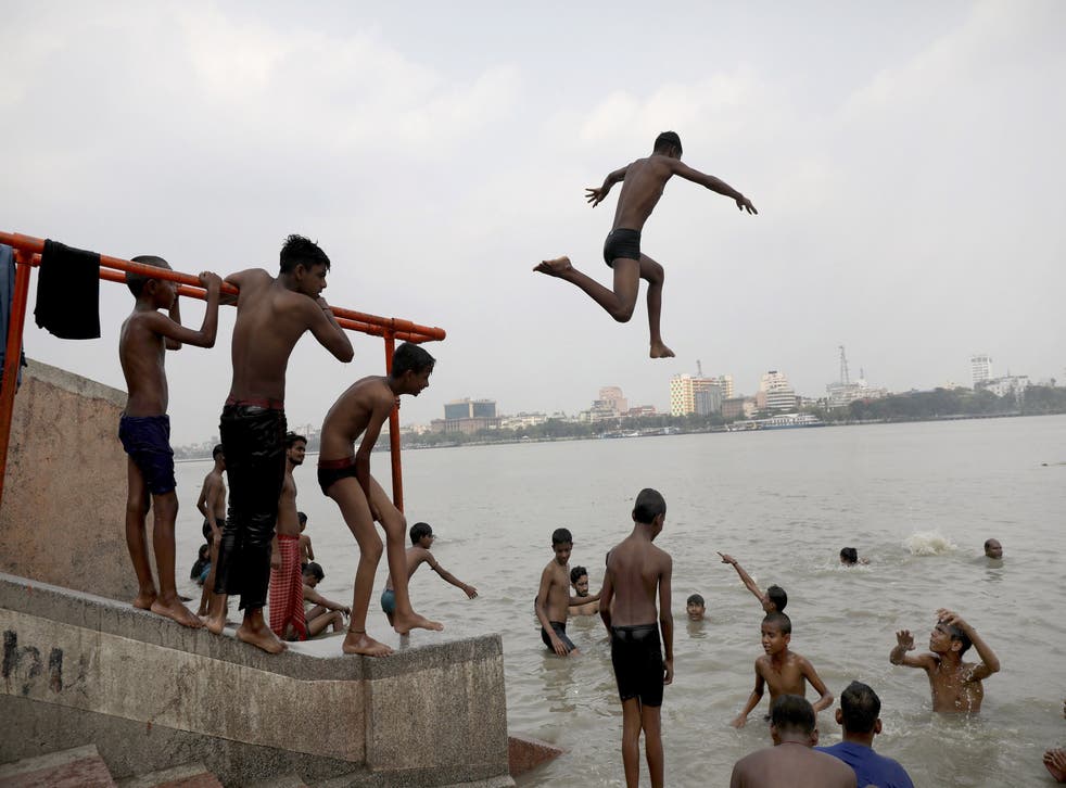 <p>A boy dives into the Ganges River during a hot day in Kolkata, India.</p>