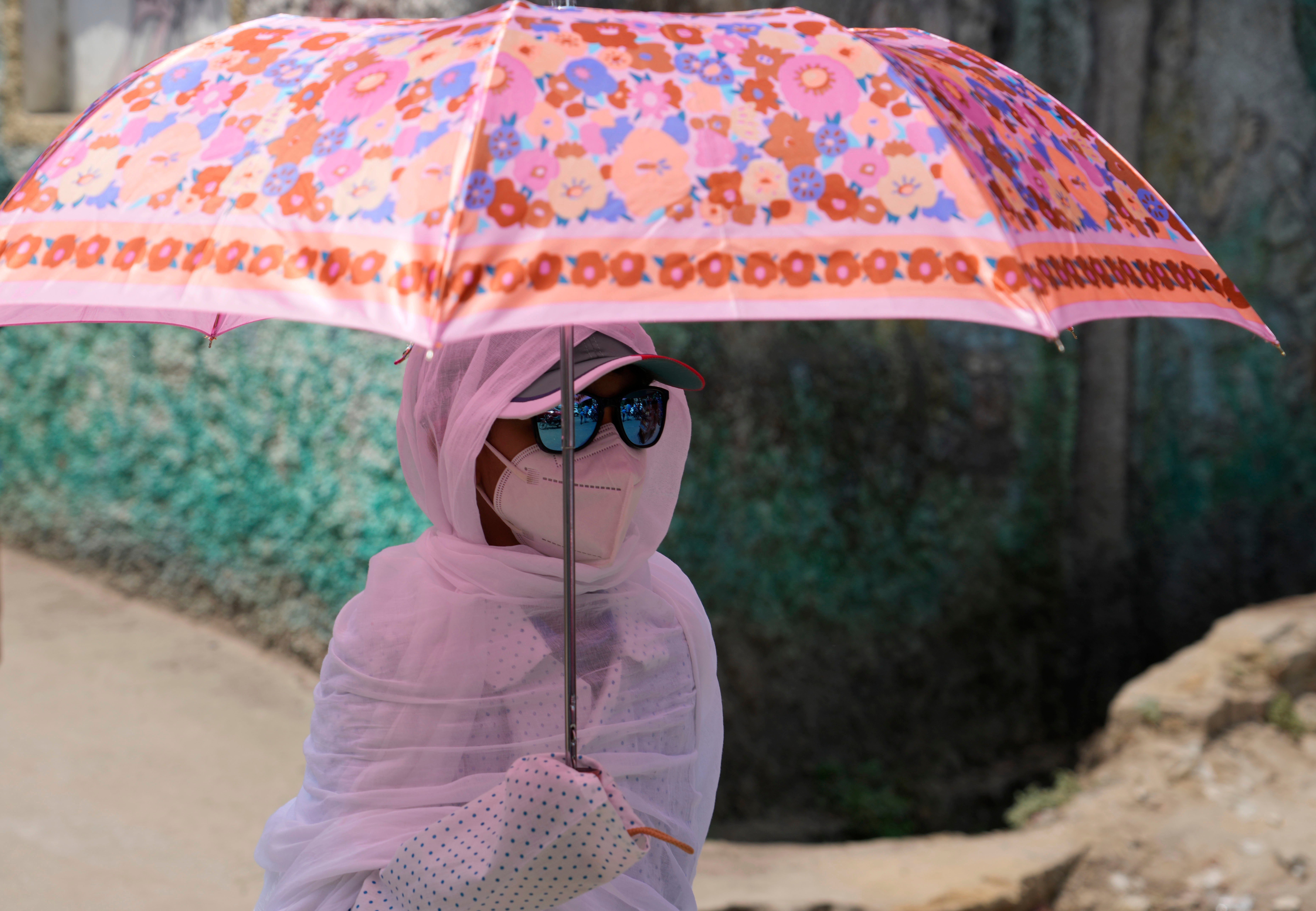 A schoolgirl protects herself from the sun in Prayagraj, in the northern Indian state of Uttar Pradesh.