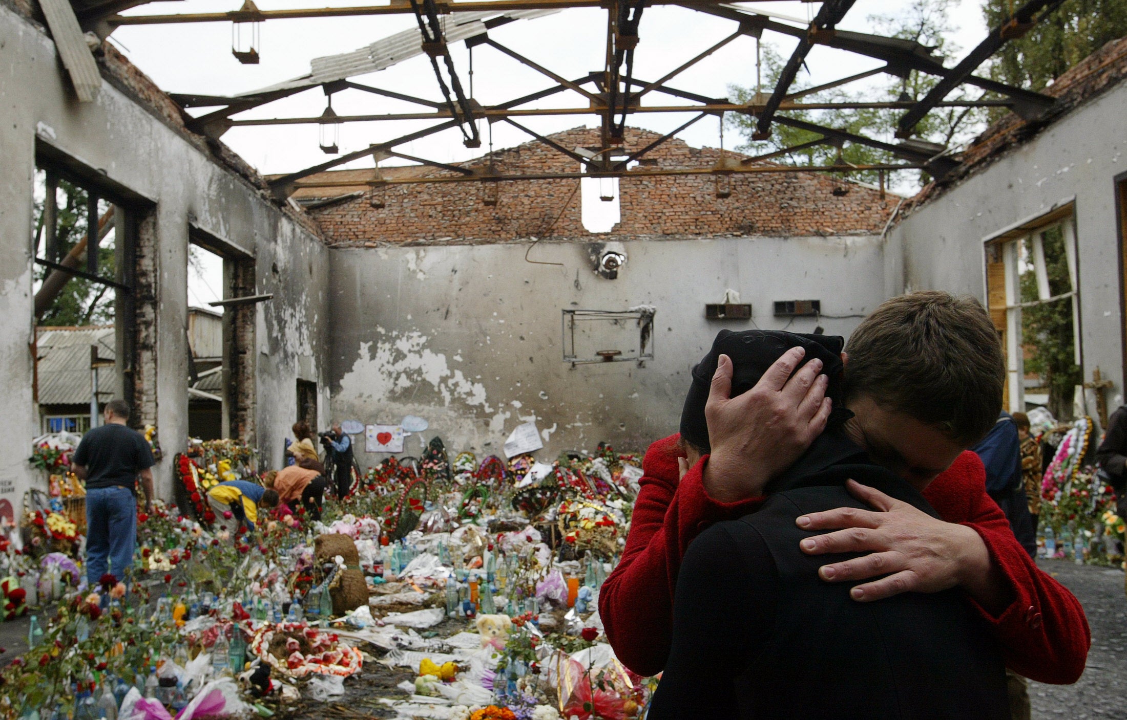 Ossetian women mourn at the destroyed school’s gymnasium in Beslan