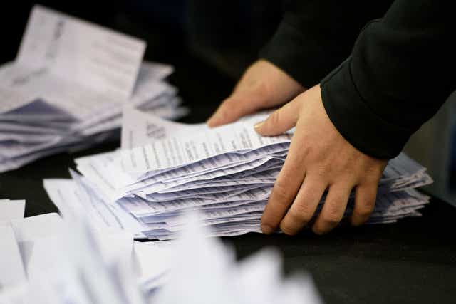 Election staff count ballot papers for the local elections at the Emirates Stadium in Glasgow.
