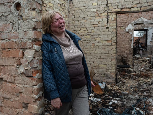 <p>Inna, 53, cries inside her burnt house on 25 April 2022 in Ozera, Ukraine</p>