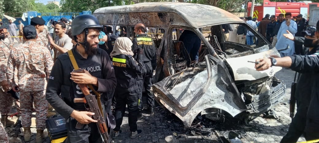 Pakistani security officials inspect the scene of an explosion in Karachi, Pakistan