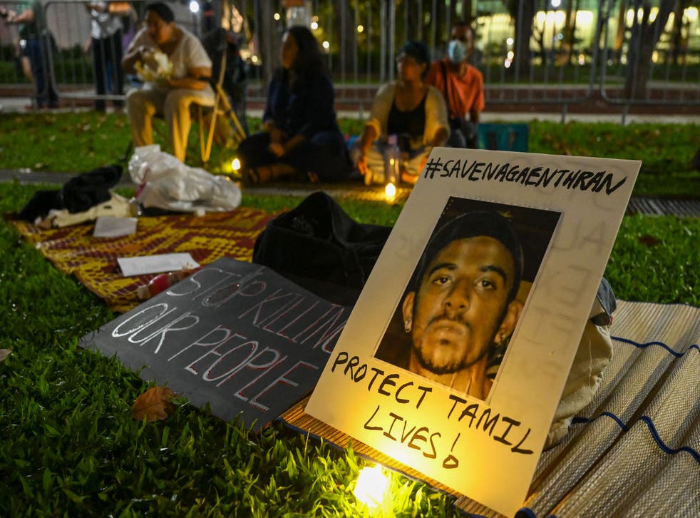 <p>People display placards and during a vigil for Malaysian national Nagaenthran Dharmalingam, sentenced to death for trafficking heroin into Singapore</p>