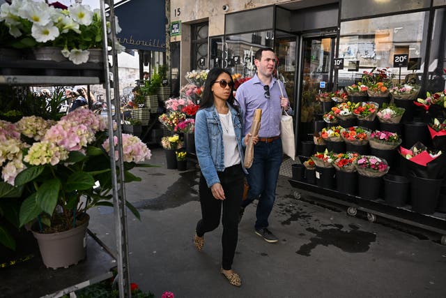 <p>Shoppers in Paris on the day after Macron’s re-election</p>