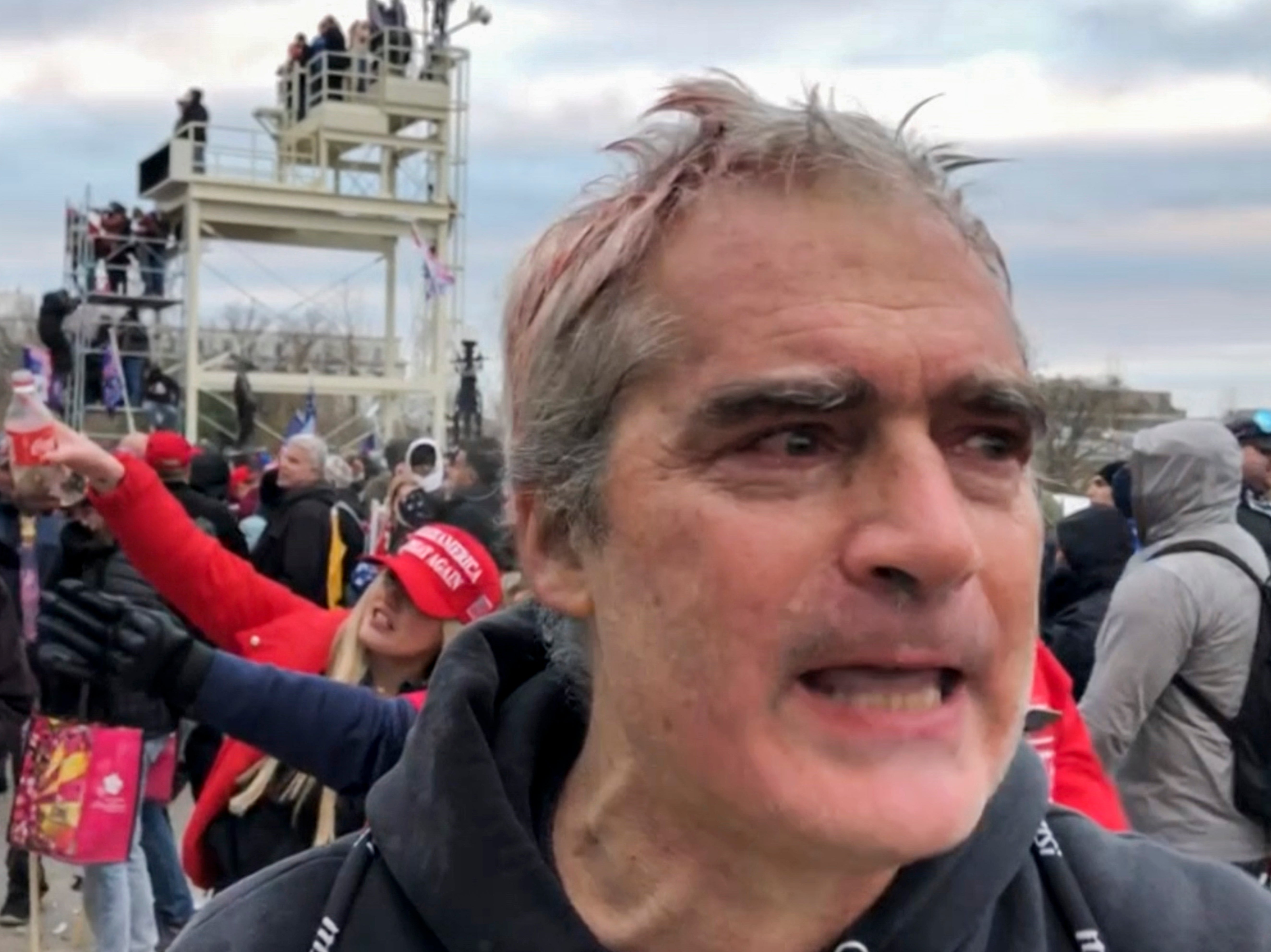 This image from video recorded Jan. 6, 2021, captures Vincent Gillespie on the grounds of the U.S. Capitol in Washington where prosecutors say he was among a rioting mob trying to gain control of the building from the federal government. (AP Photo/Ben Fox)