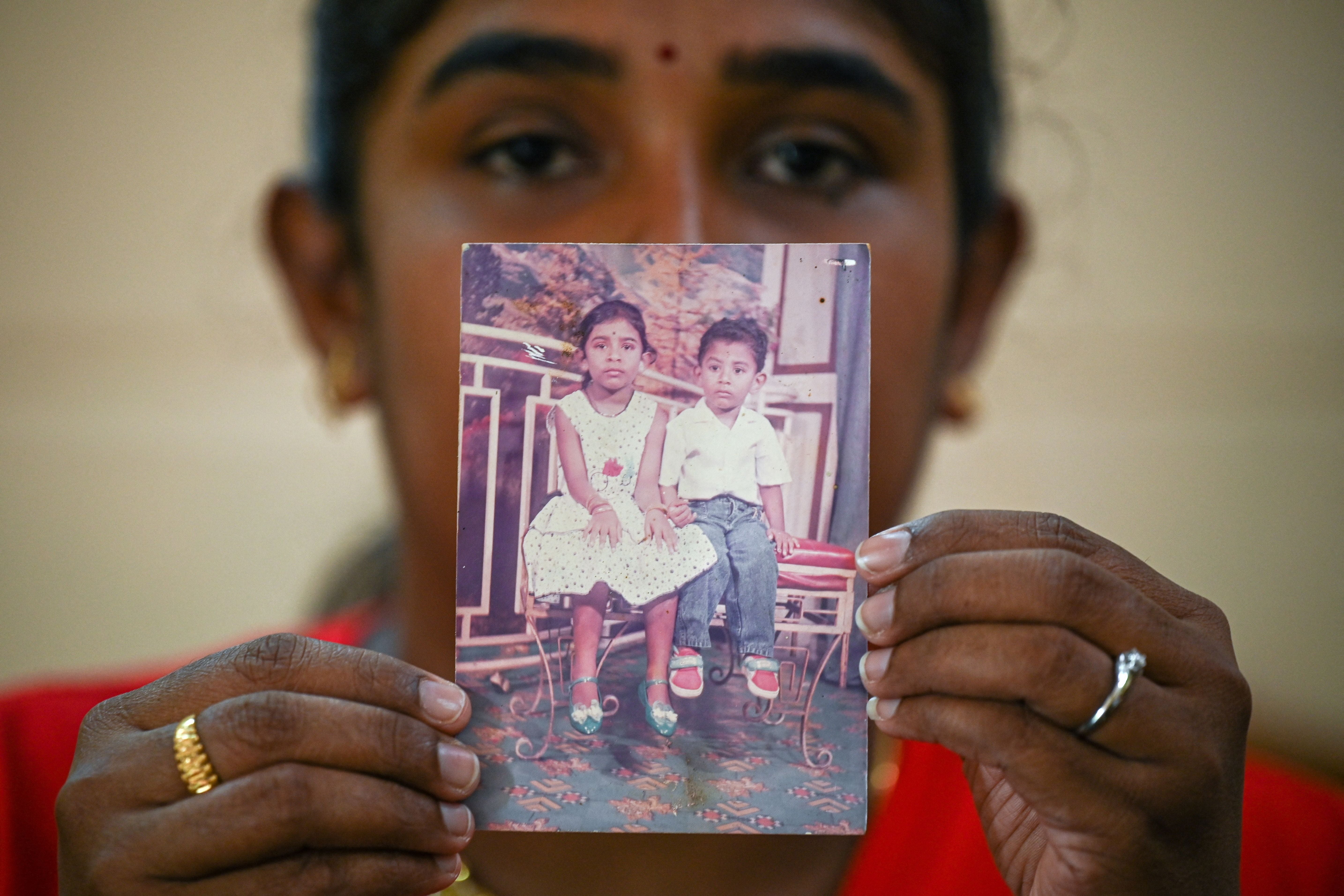 Sarmila Dharmalingam, elder sister of Nagaenthran Dharmalingam shows a photograph of herself and her brother in Malaysia’s Perak state