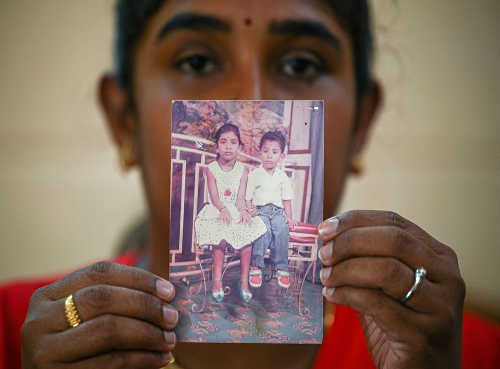 <p>Sarmila Dharmalingam, elder sister of Nagaenthran Dharmalingam shows a photograph of herself and her brother in Malaysia’s Perak state</p>