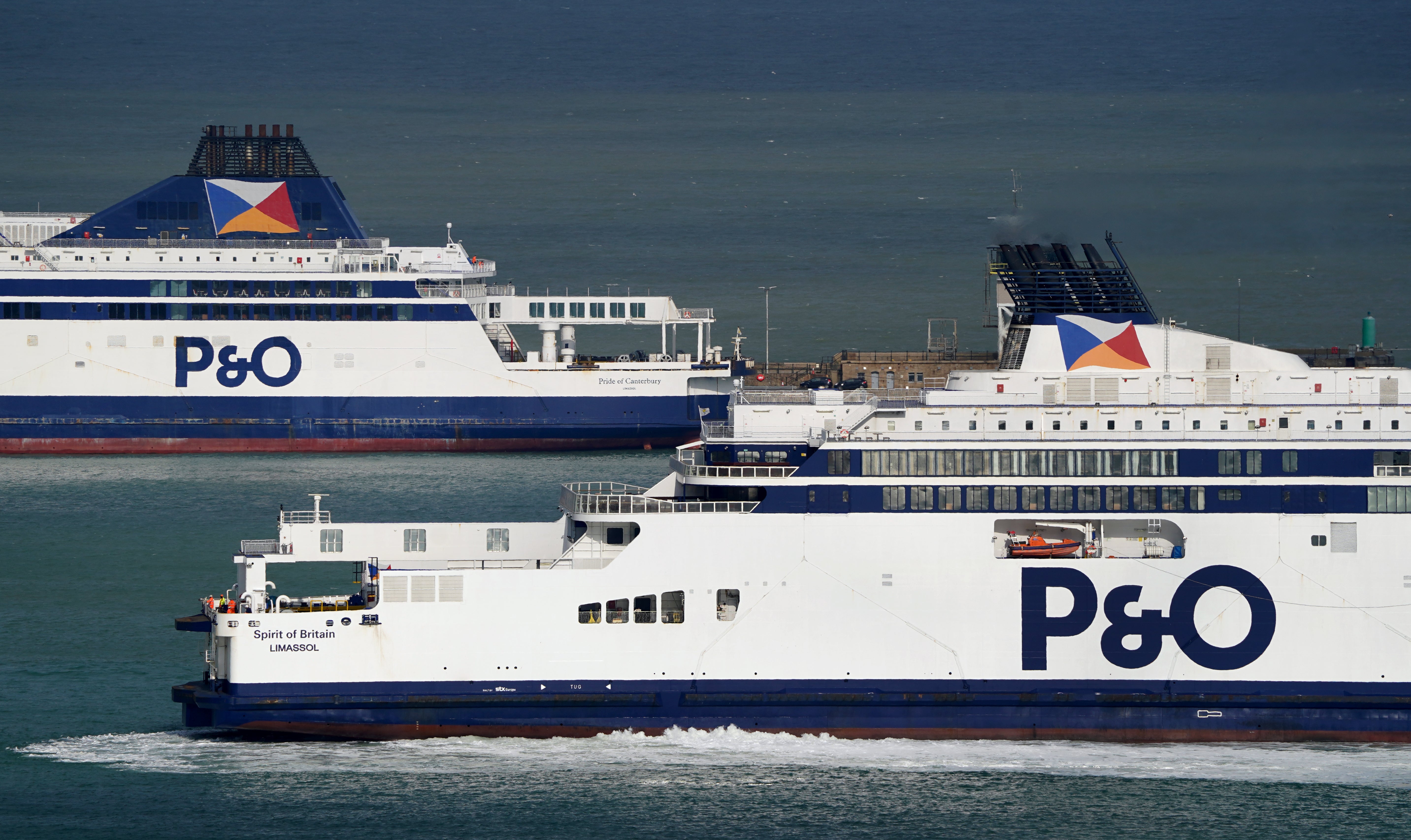 The P&O Ferries vessel Spirit of Britain (bottom) arrives back at the Port of Dover in Kent