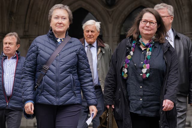 <p>Cathy Gardner (second left) and Fay Harris (second right), whose fathers died from Covid-19, leave the Royal Courts of Justice after the ruling  yesterday </p>