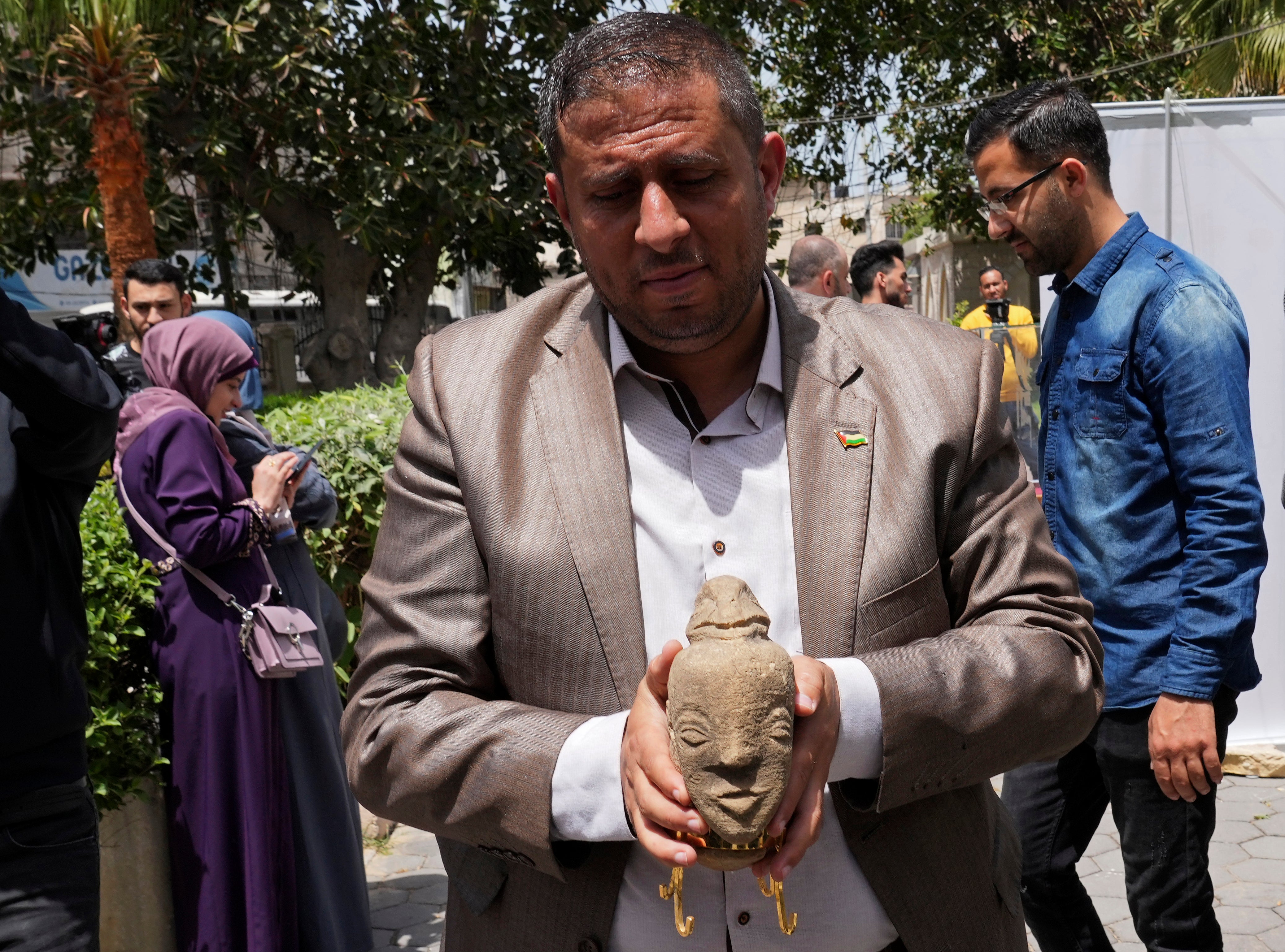 An employee of the ministry of tourism and antiquities holds the rare 4,500-year-old stone sculpture